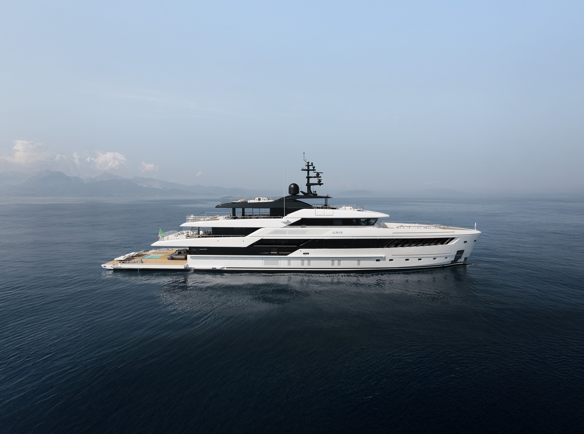 Aft exterior architecture of the Sanlorenzo 50Steel beside the water