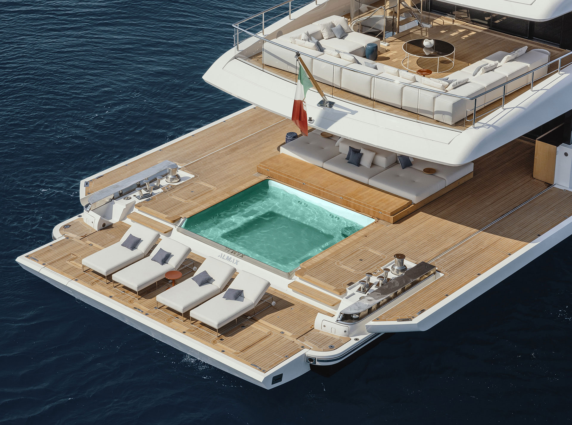 Sanlorenzo 50Steel illuminated at dusk on calm water