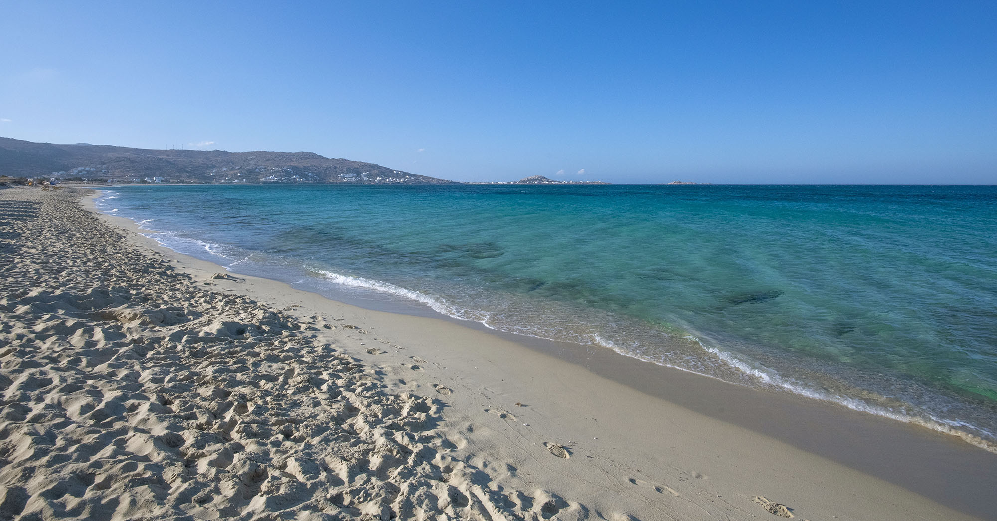 Long sandy coast and clear sea at Plaka on Naxos