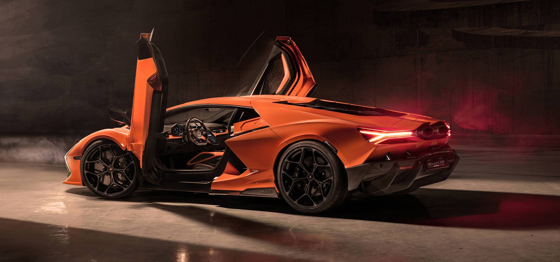 Orange Lamborghini Revuelto shown from the rear with both doors open