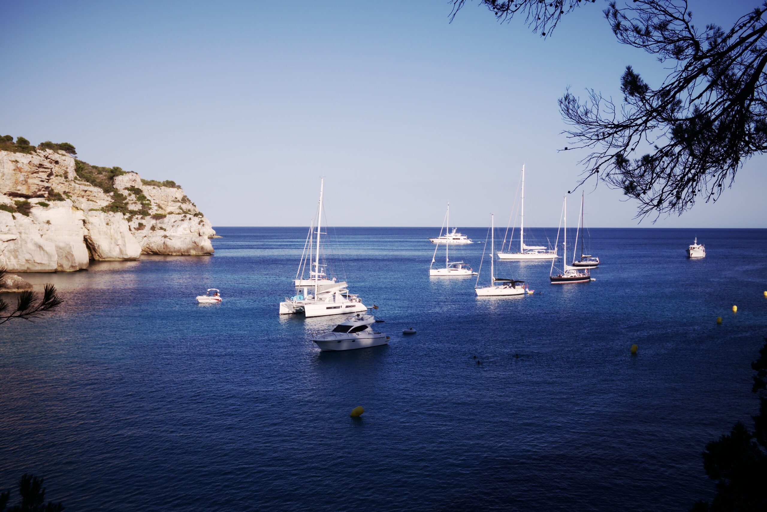 Limestone, pine and clear blue water near Cala Macarella on Menorca