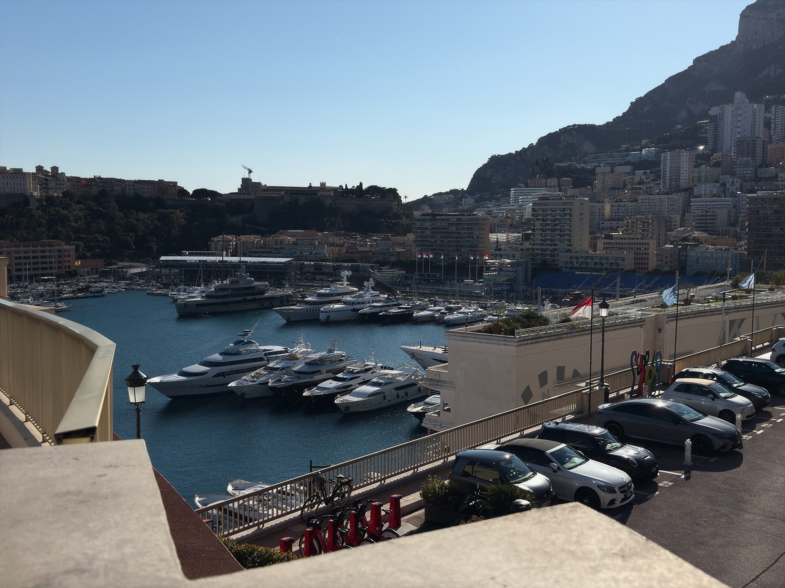 Port Hercule filled with yachts beneath Le Rocher in Monaco