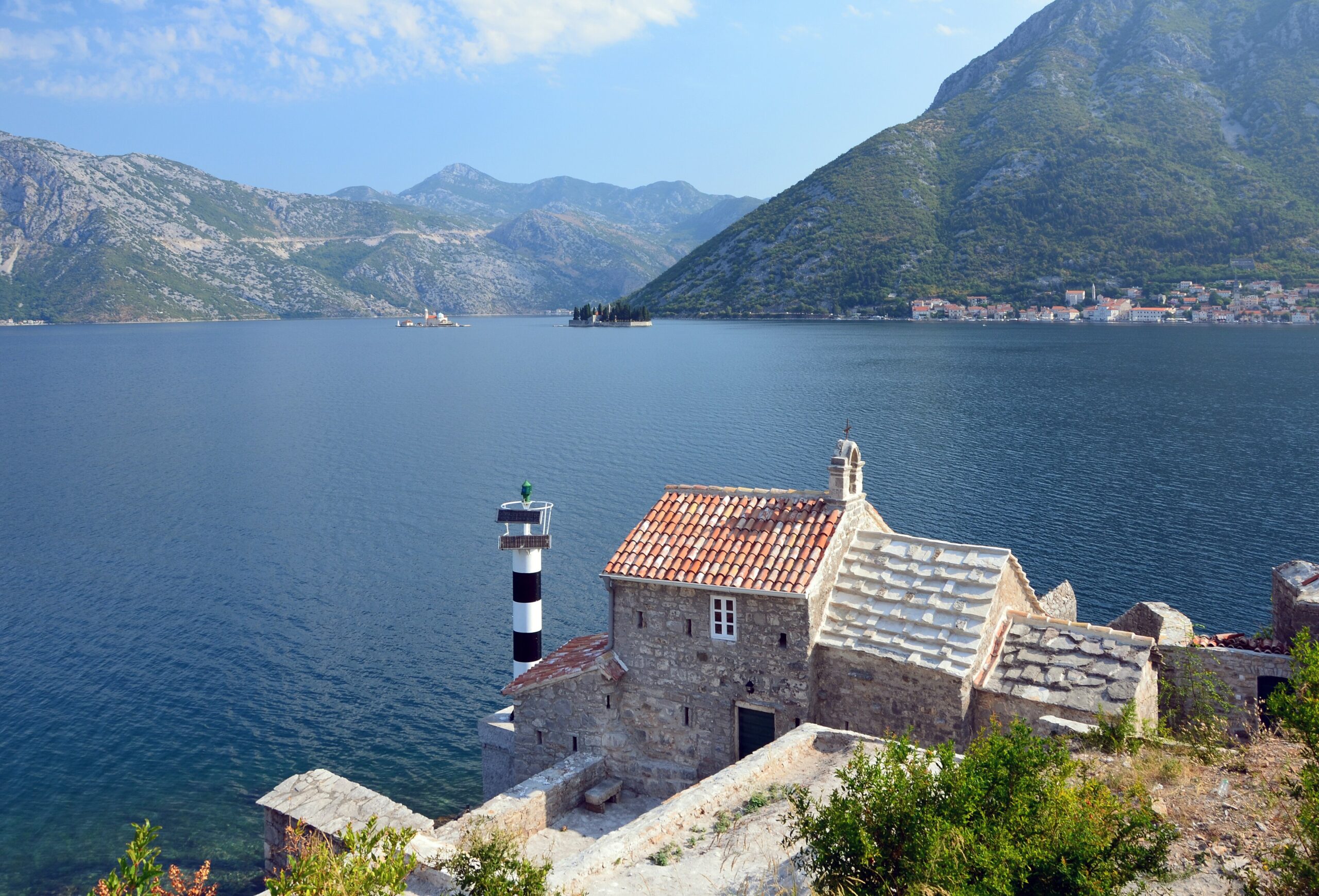 Deep blue water and mountain slopes in the Bay of Kotor seen from above Lepetani