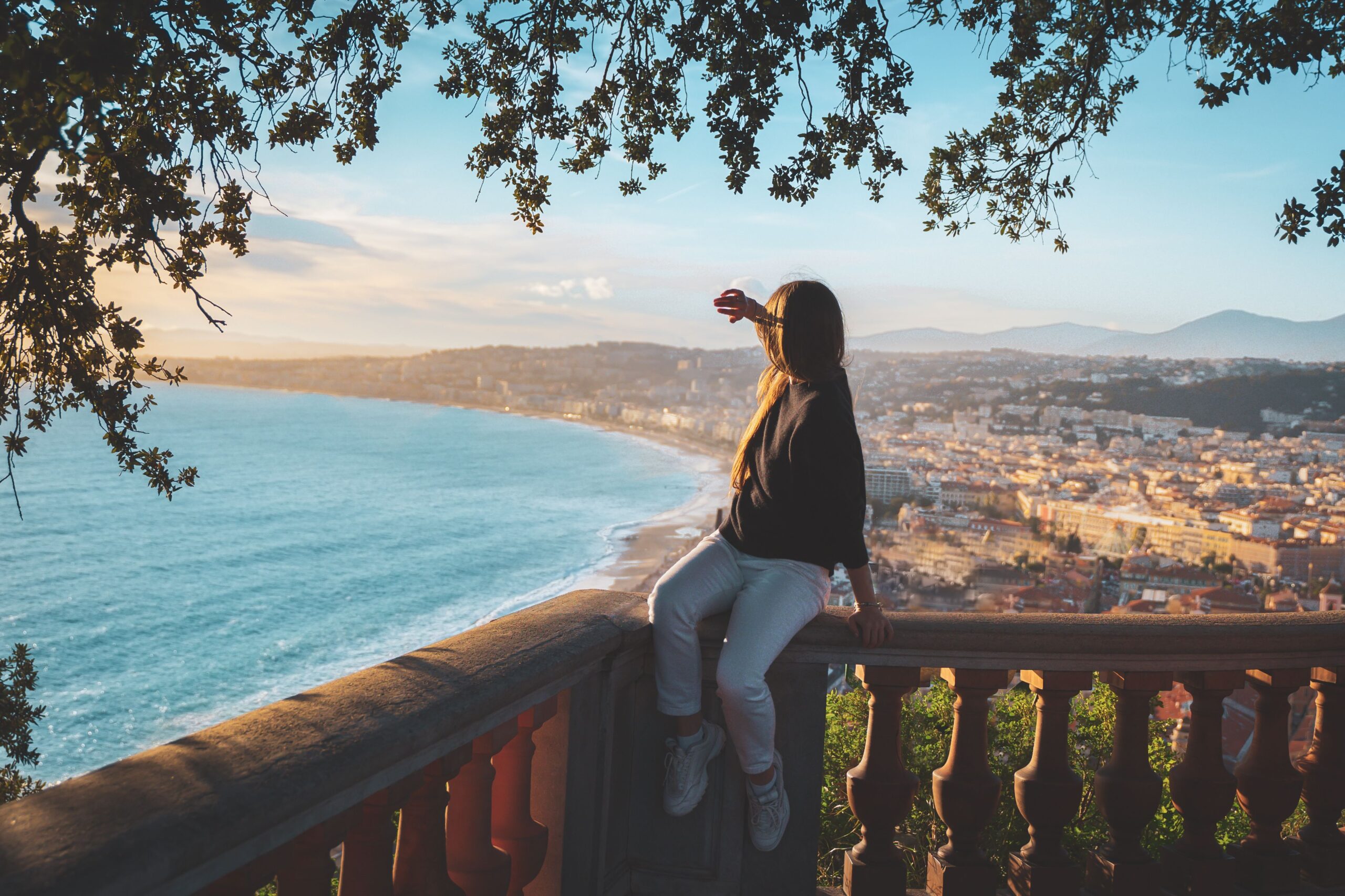 Traveller overlooking Nice and the Baie des Anges from an elevated viewpoint