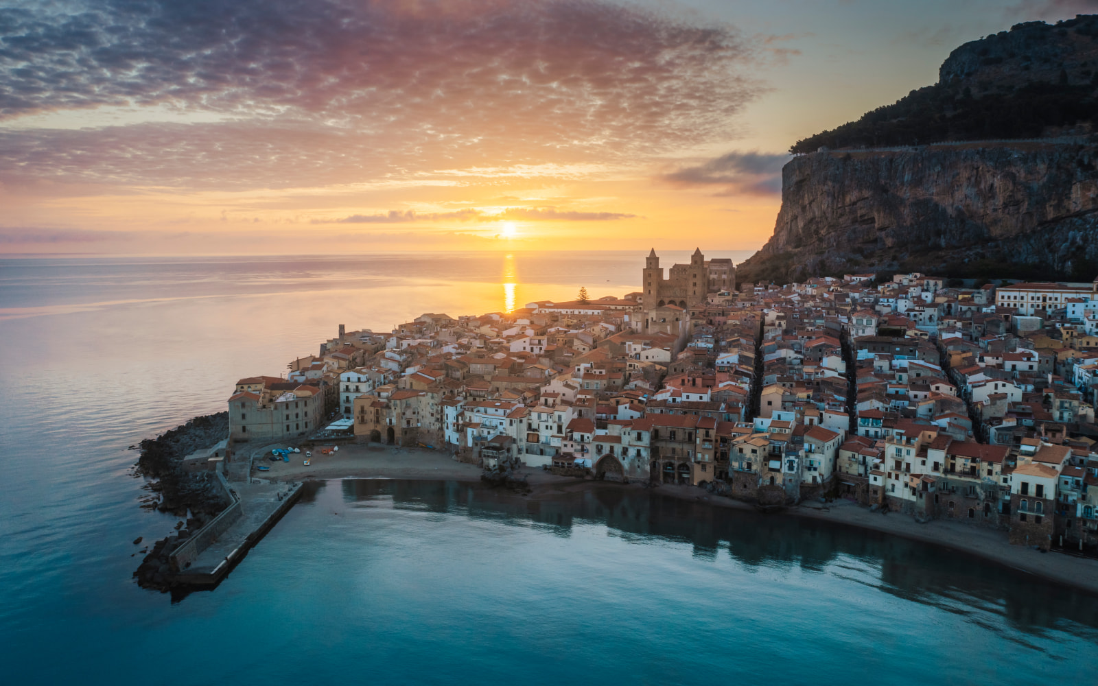 Aerial view of Cefalù and the northern coast of Sicily at sunset