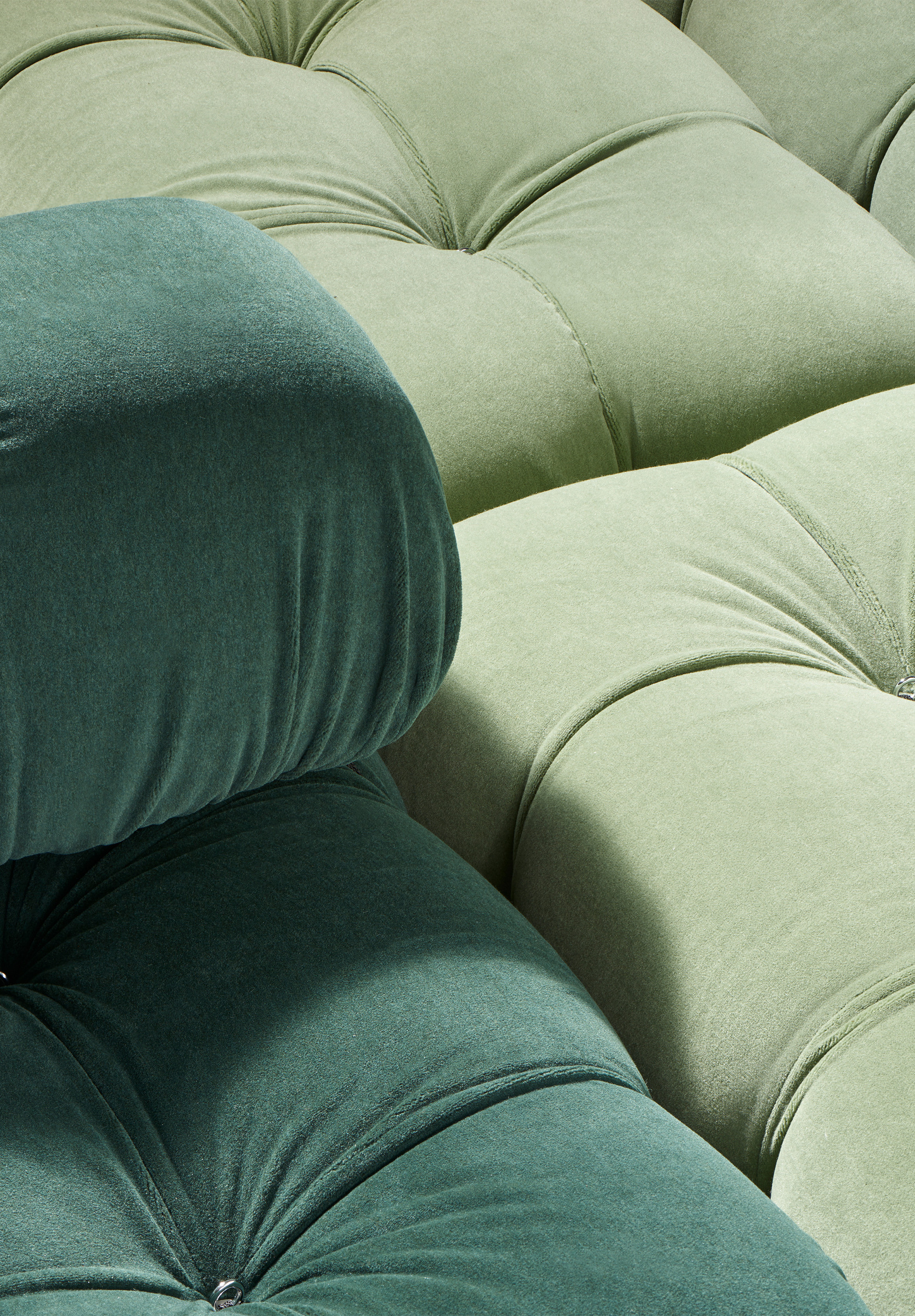 The rounded green upholstery and the edge of a module in close detail