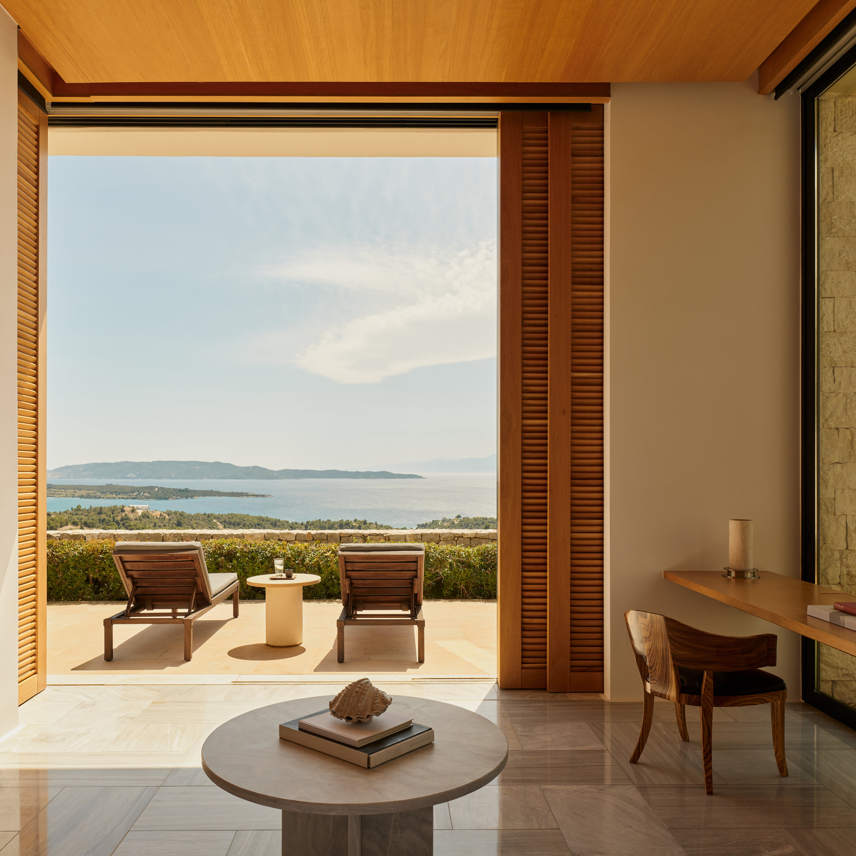 A doorway framing the terrace of an Amanzoe villa