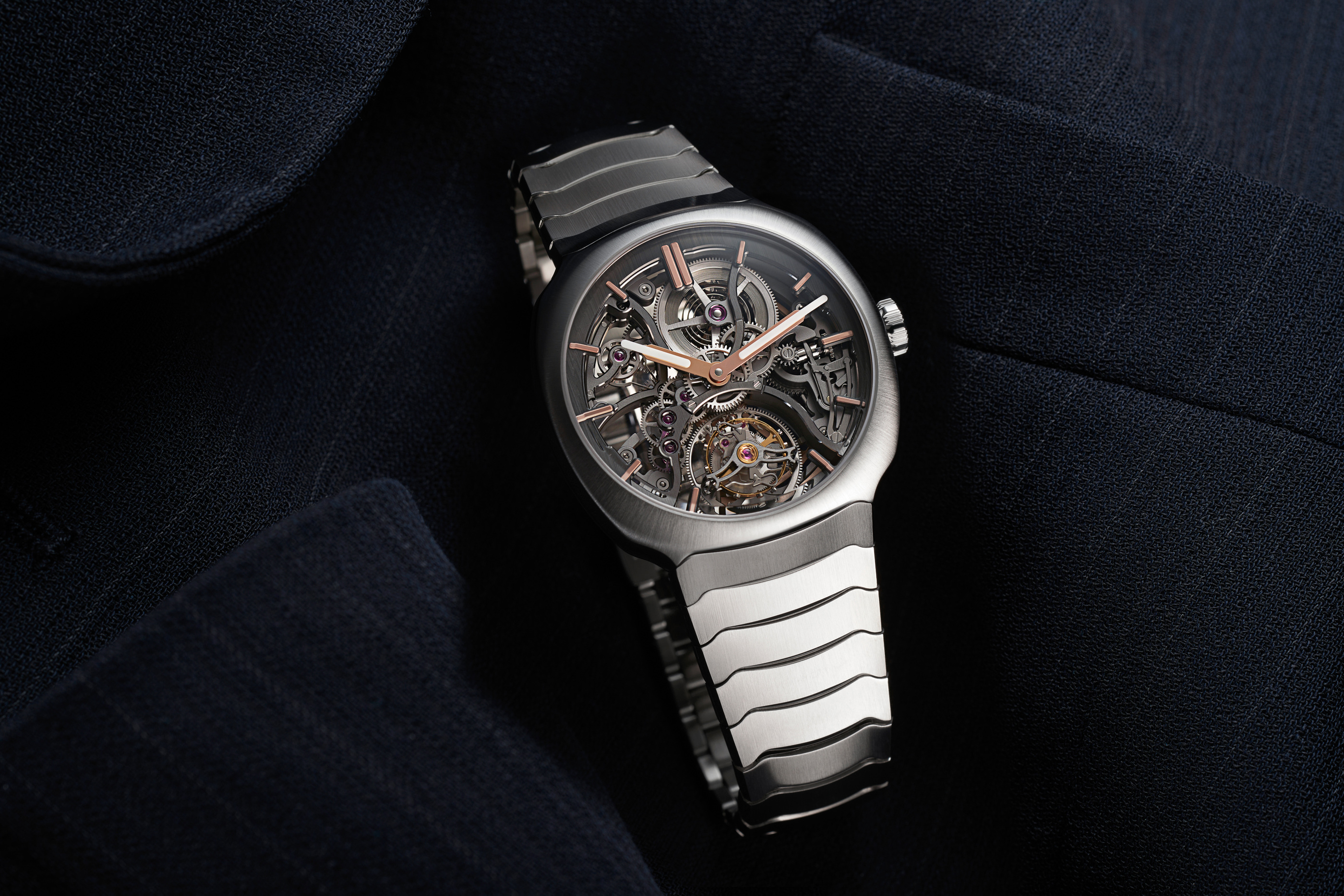 The steel watch resting on fabric in an official styling study