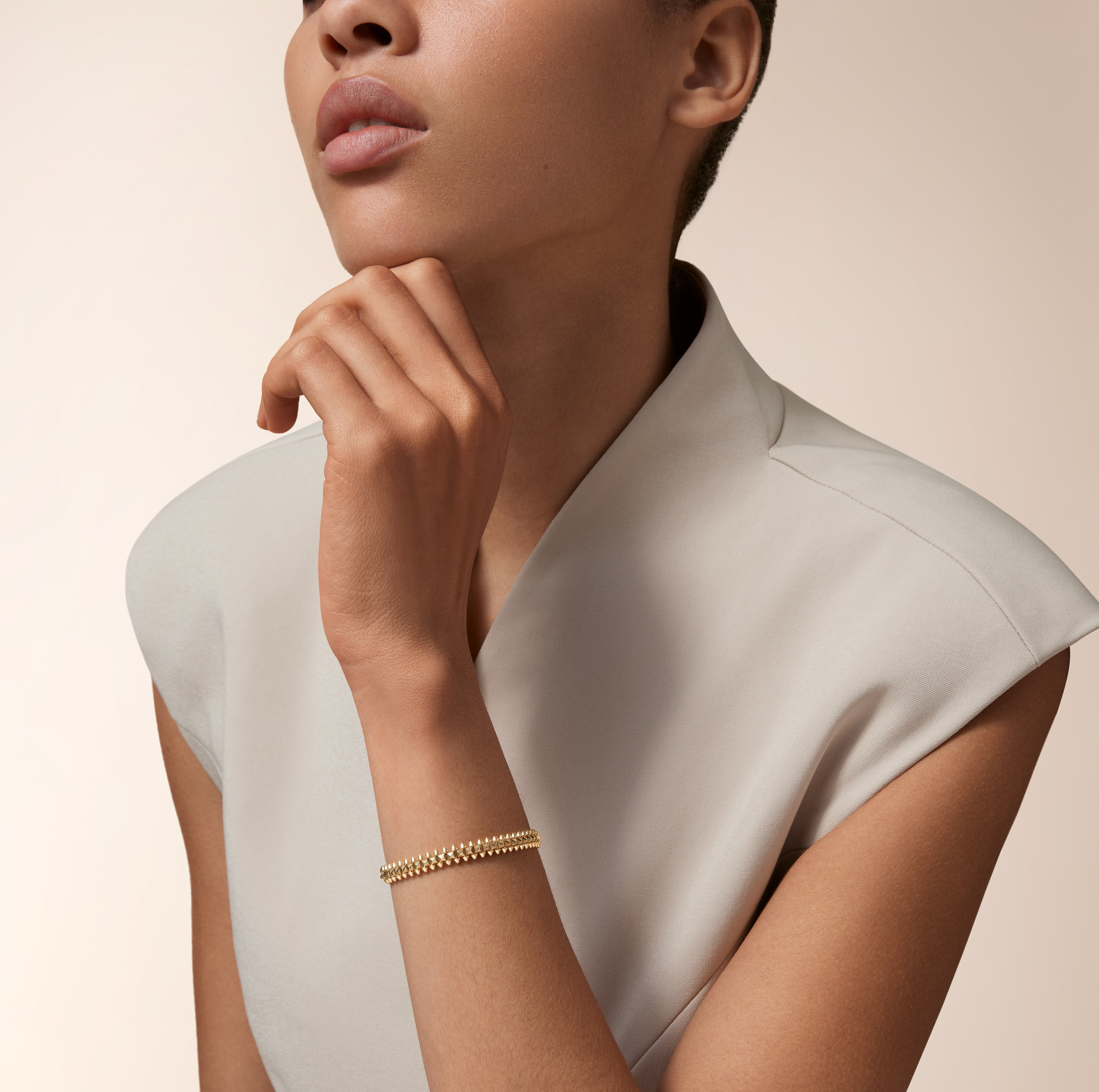 Official styling view showing the yellow-gold-coloured bracelet at the wrist