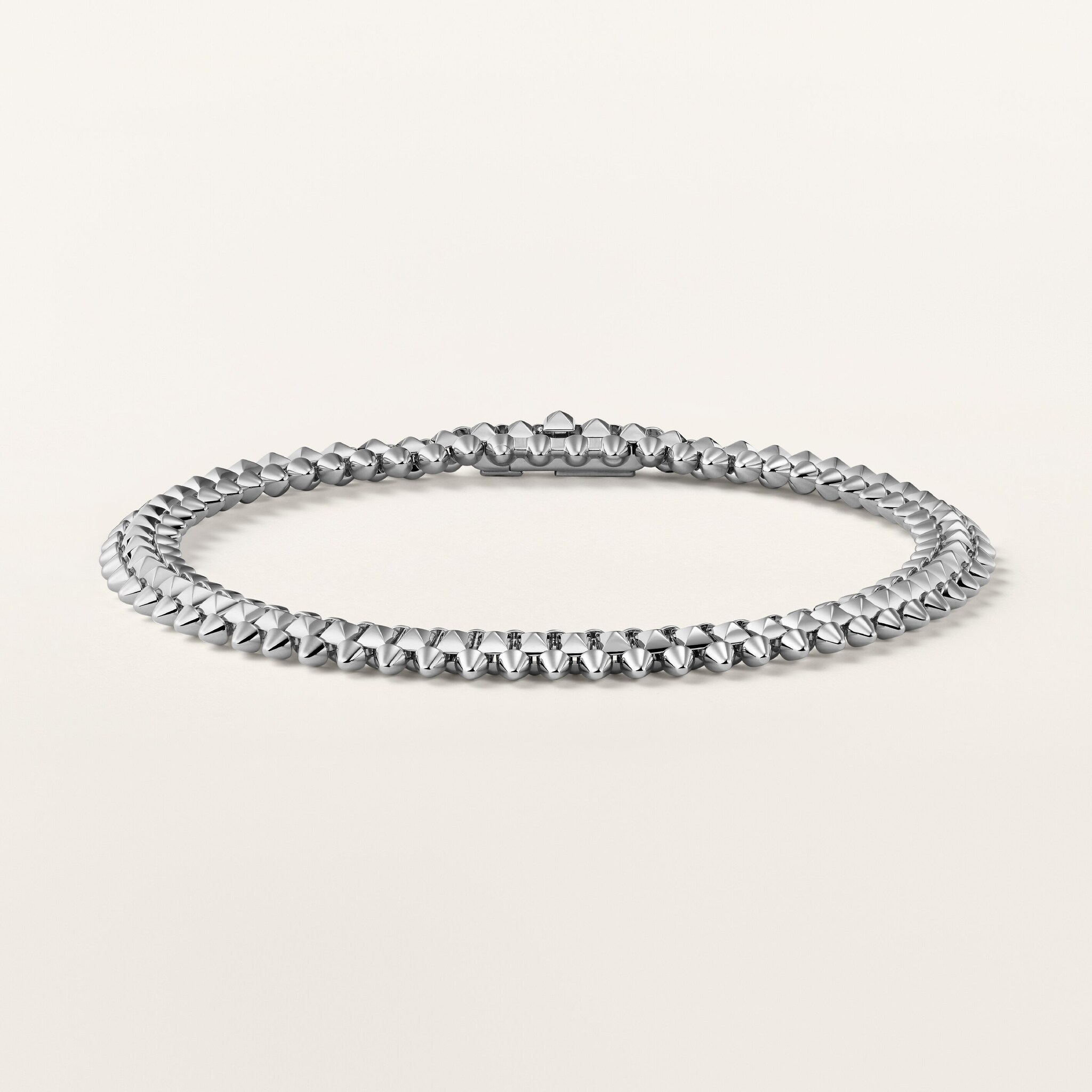 A pale-metal variant of the flexible Clash bracelet in the official studio view
