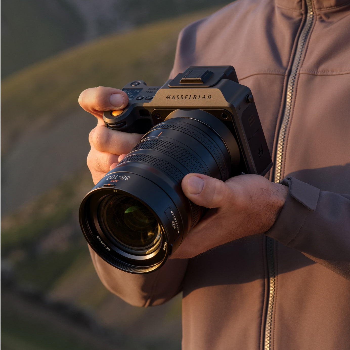 Official photograph of X2D II 100C held in a landscape setting