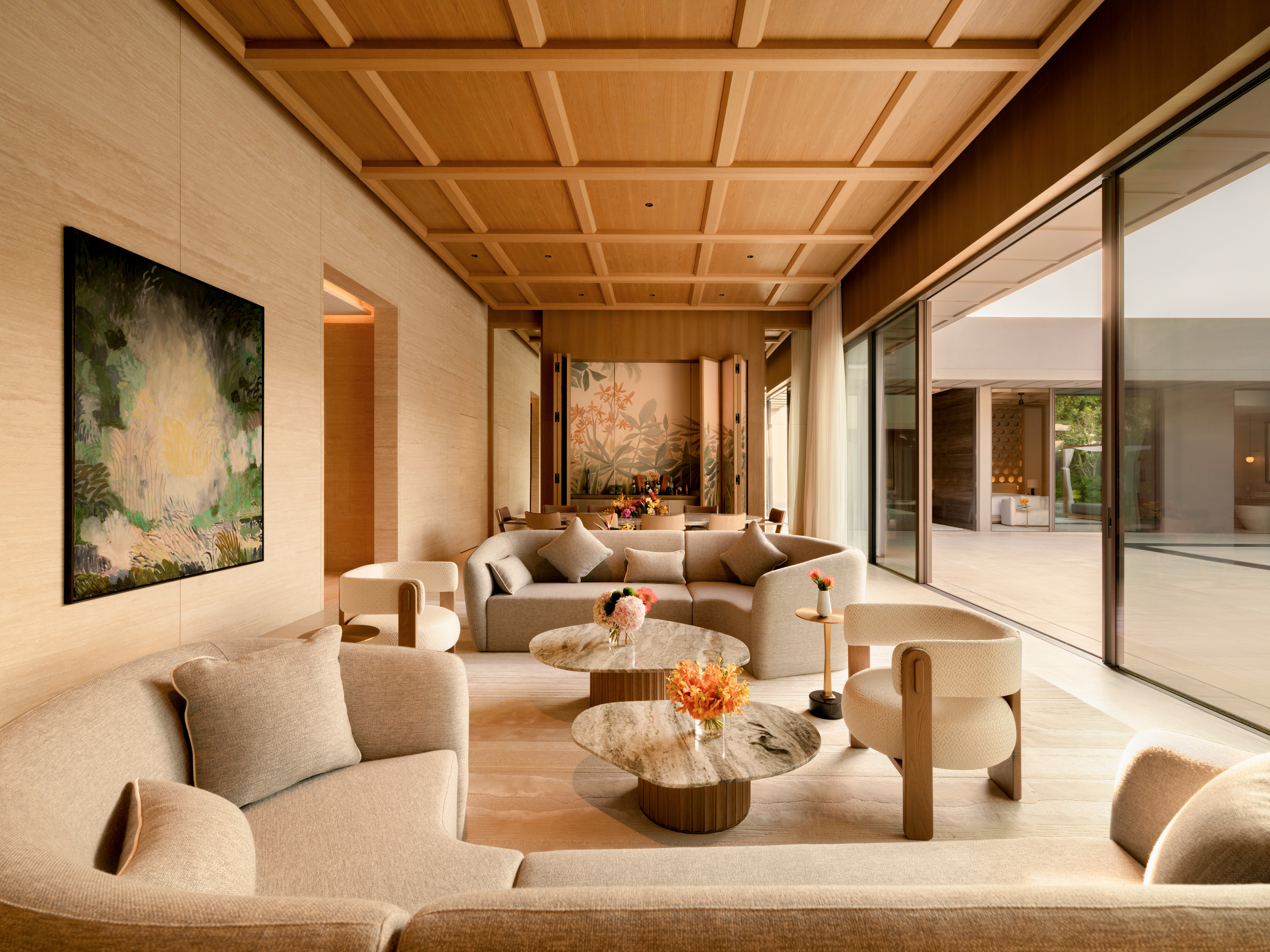 A published villa living arrangement opening towards its pool and terrace