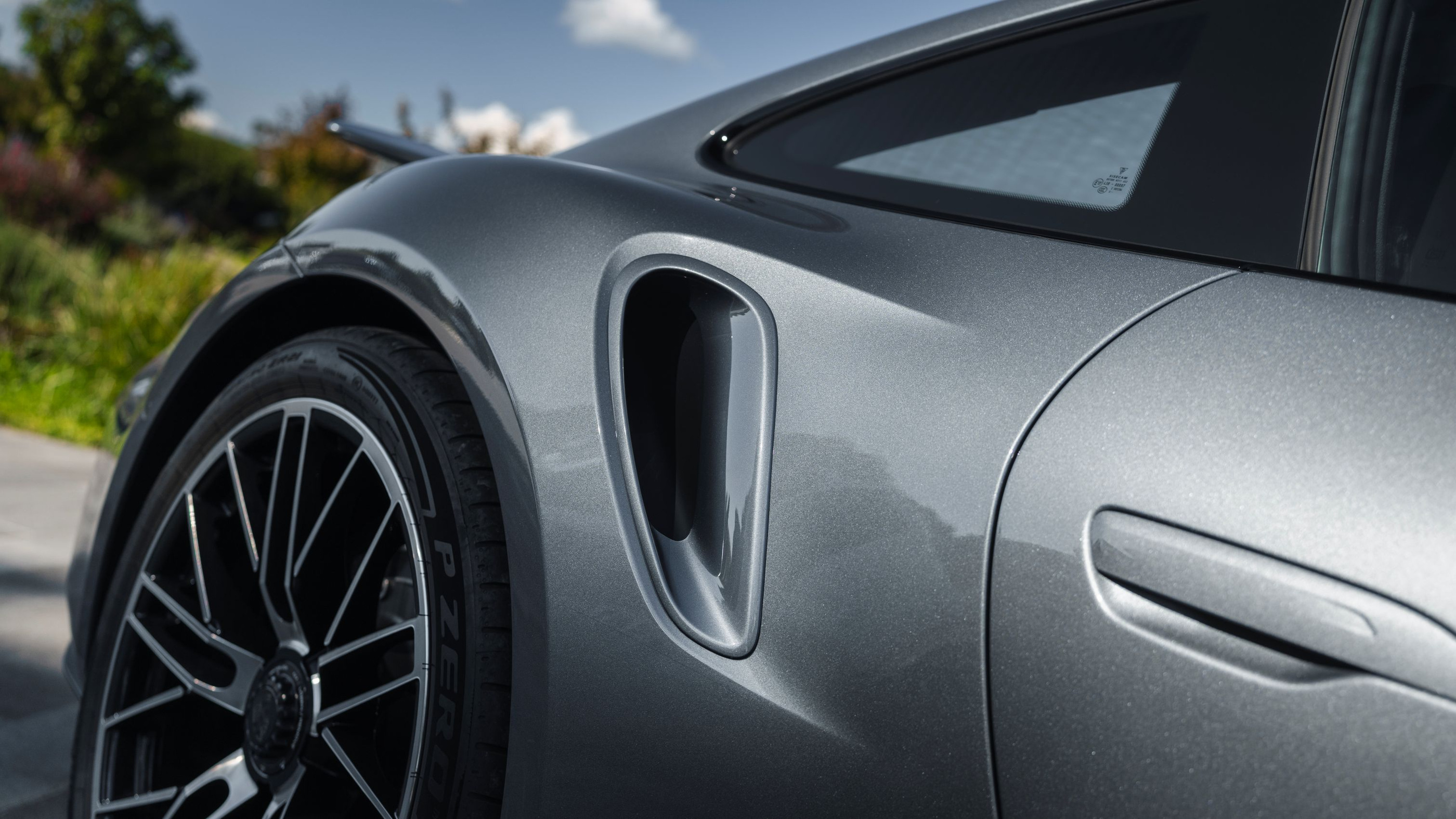 Rear-quarter intake and body surfaces in the official close view