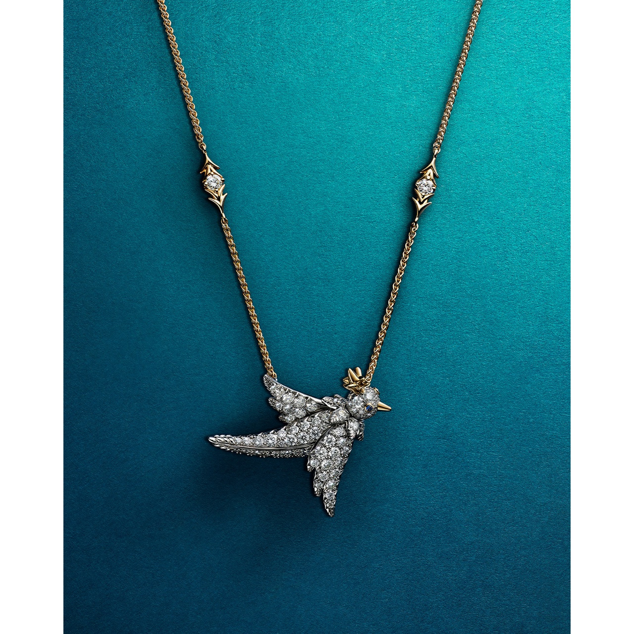 A Bird on a Rock pendant against Tiffany’s blue collection background