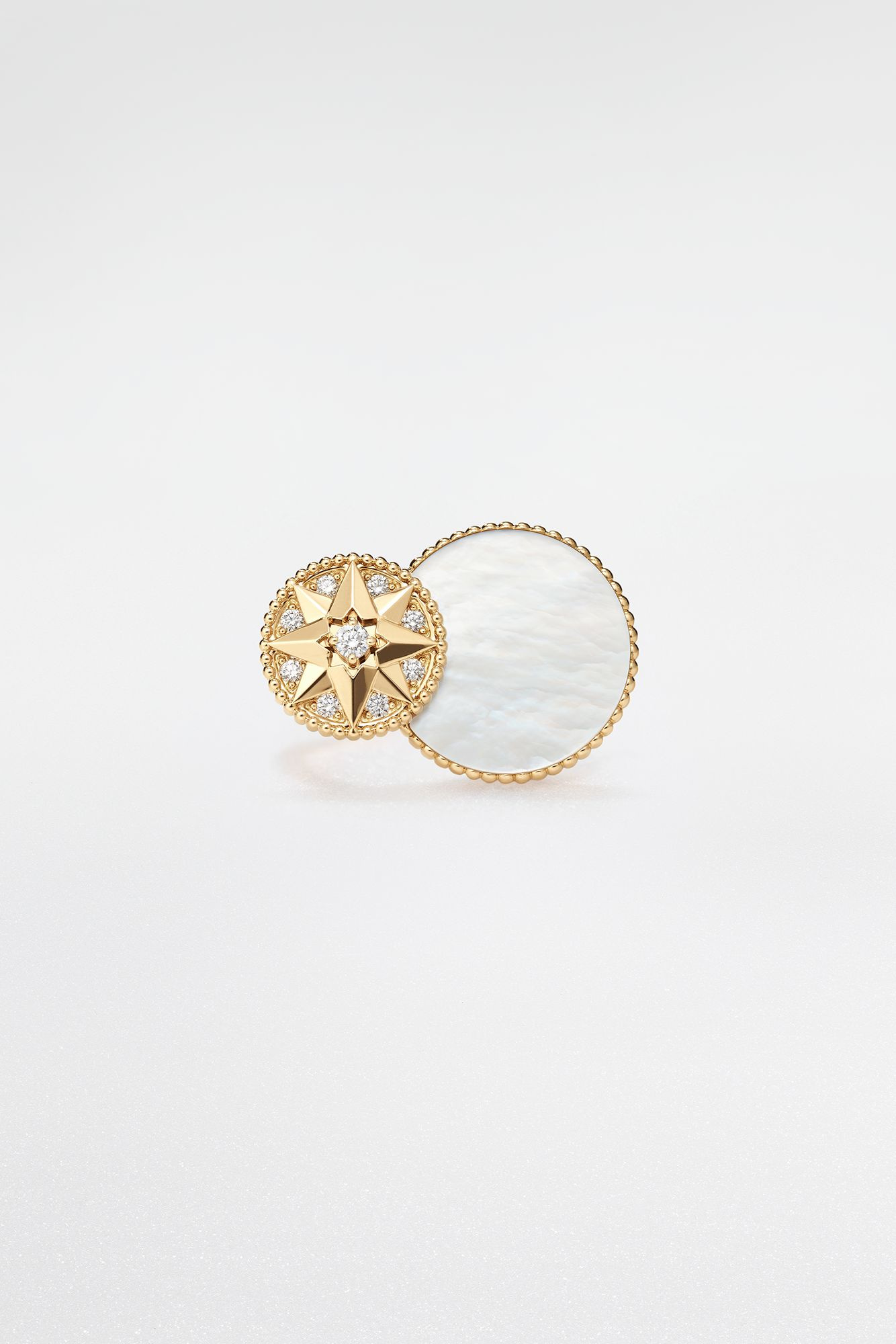 Rose des Vents ring, its star and mother-of-pearl-coloured face shown in the official studio photograph