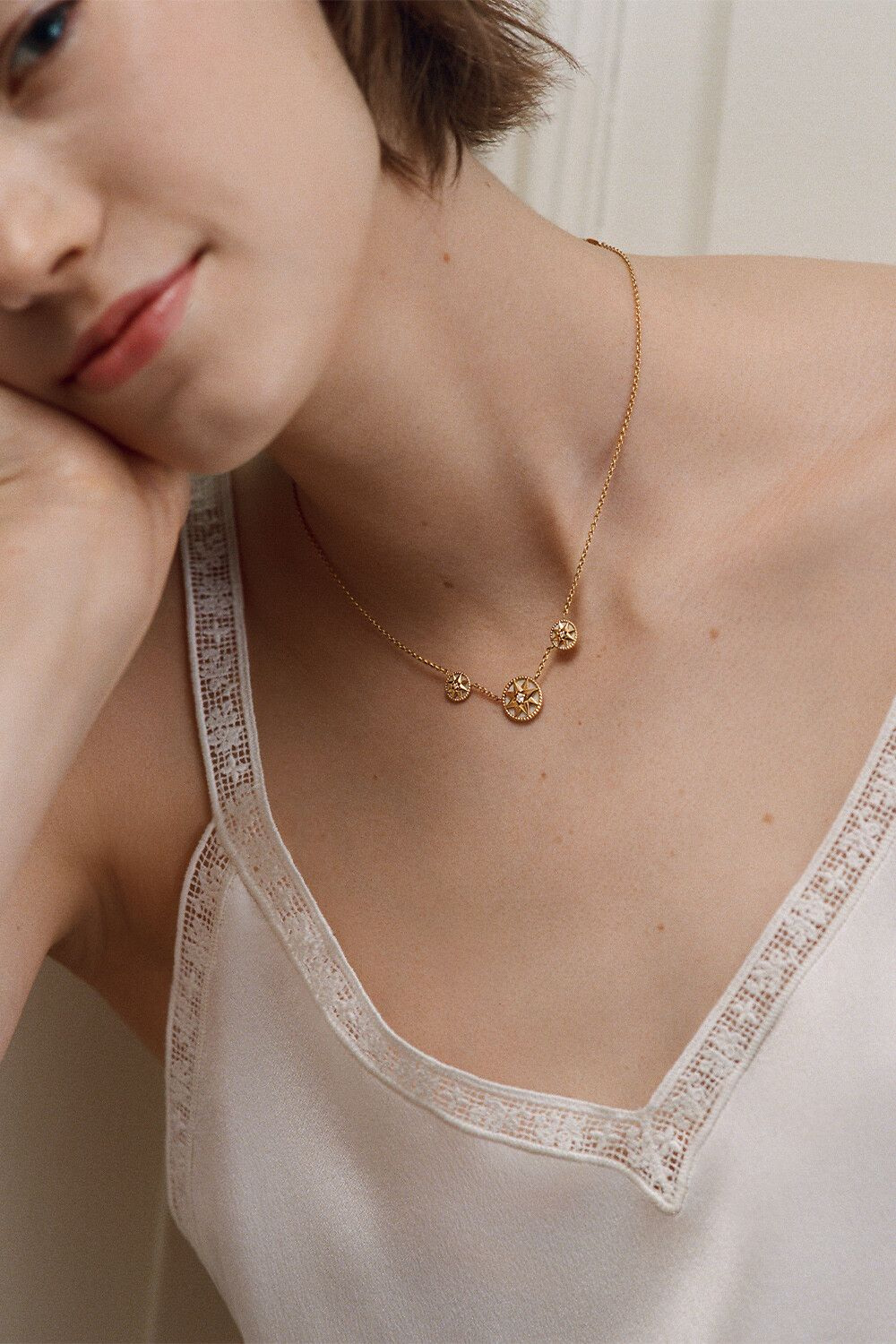 Rose des Vents necklace worn against a light shirt