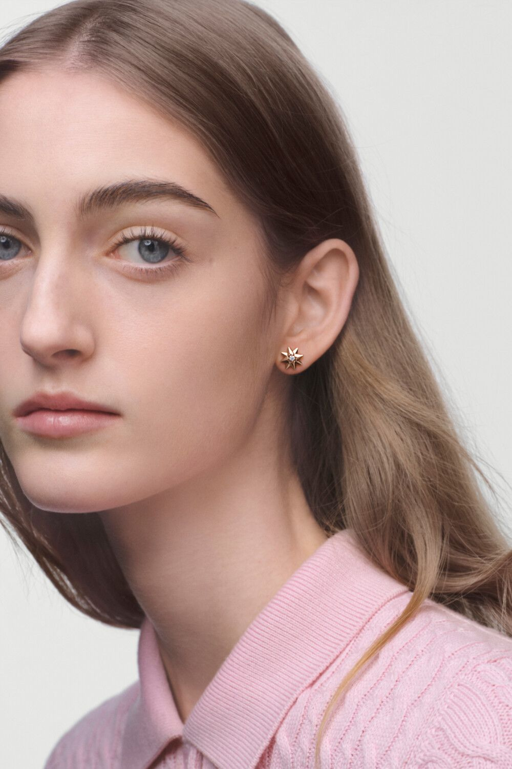 A closer worn view of Rose des Vents earrings