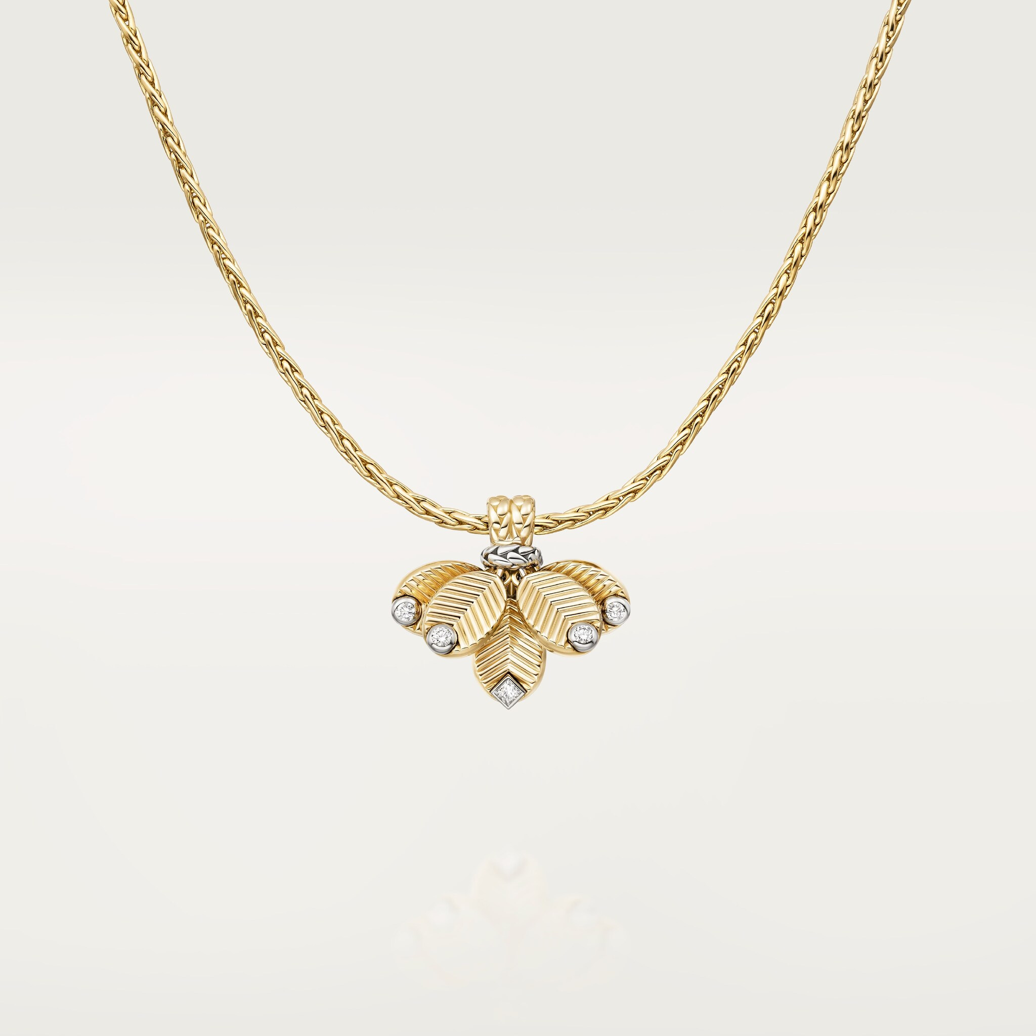 A Grain de Café necklace with its chain and pendant arrangement visible