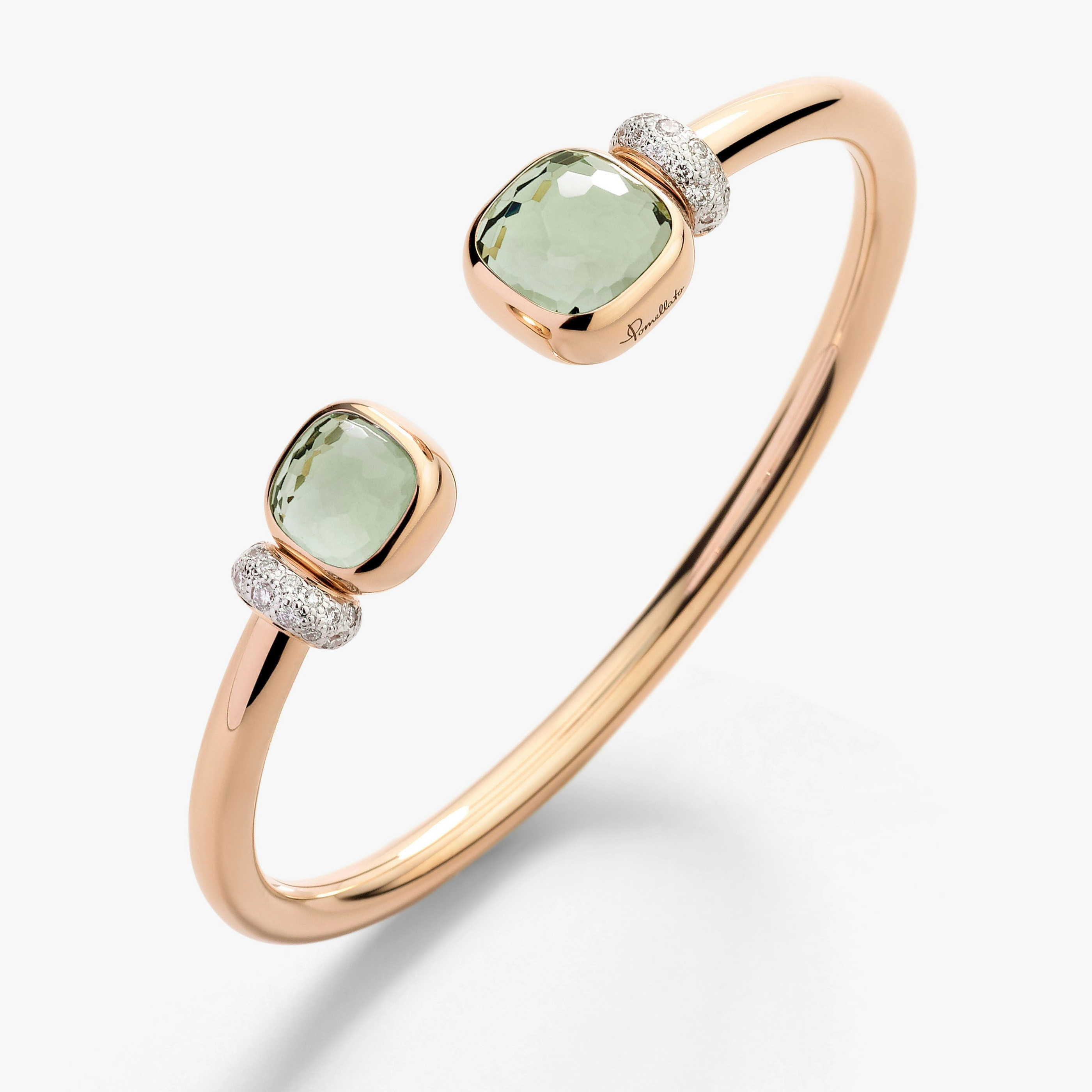 The complete open bangle, showing two unequal green stones