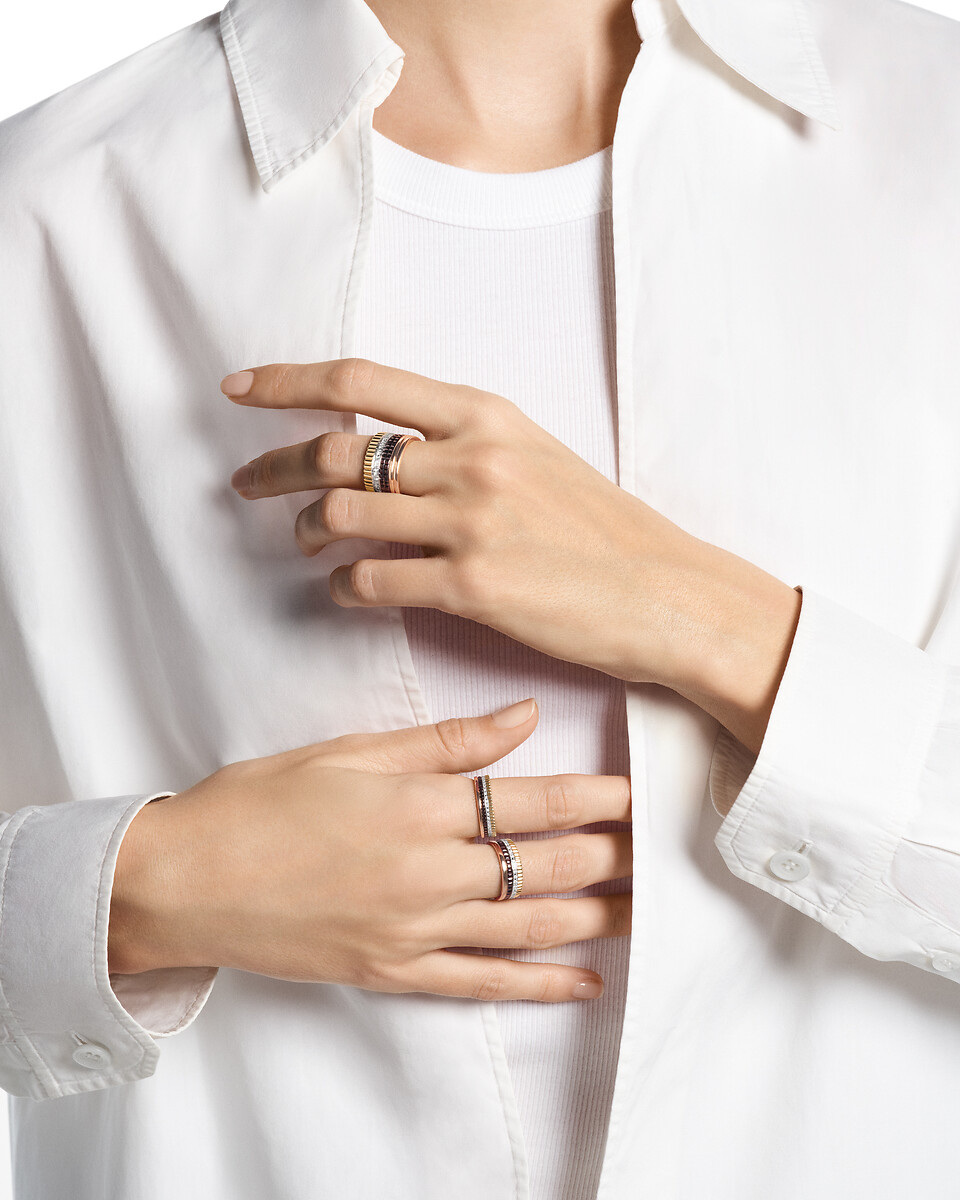 Quatre Classique rings shown on the hand with a white shirt in the official reference photograph