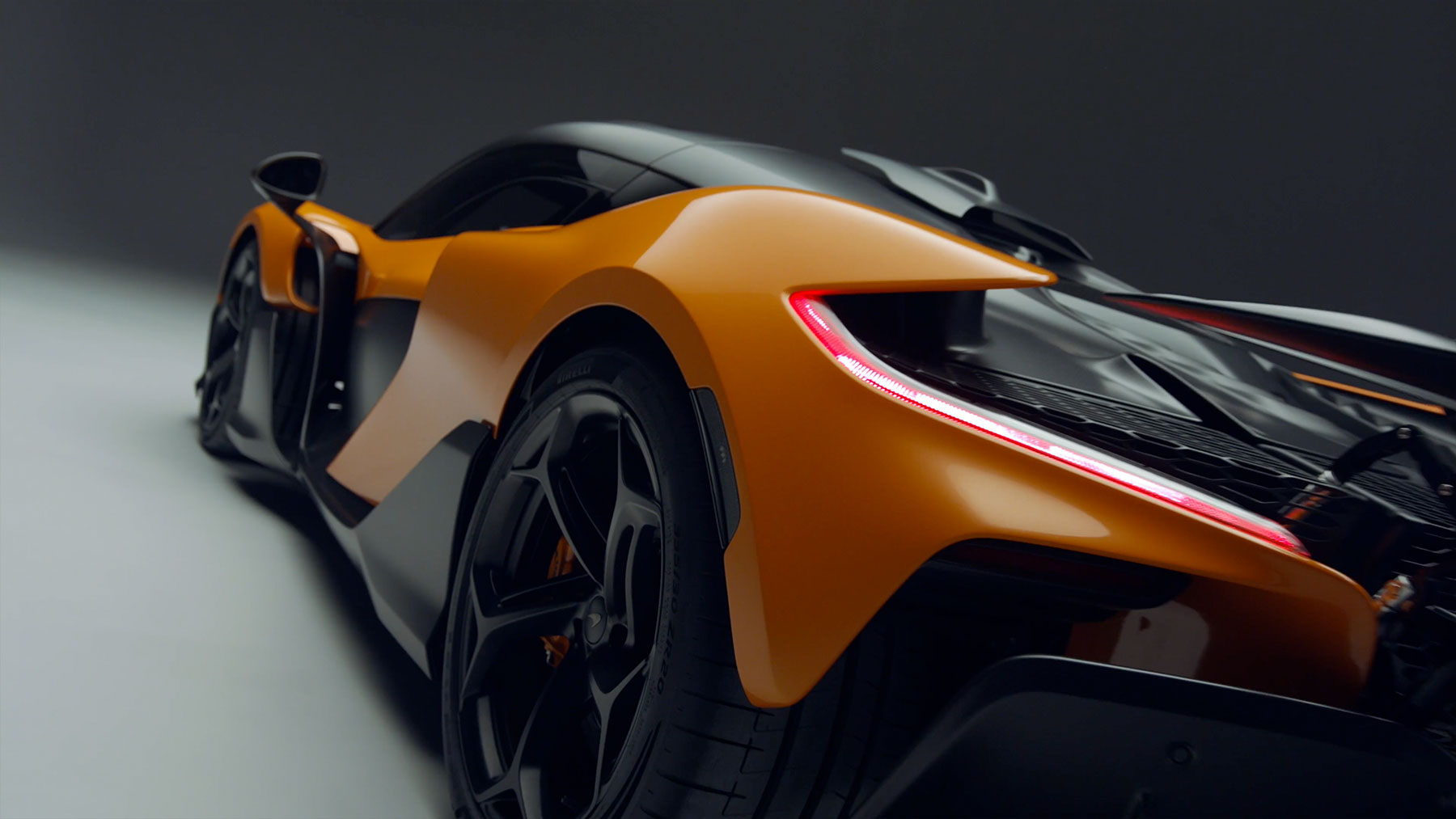 Rear-quarter W1 studio visual showing the relationship between cabin, intake and tail.