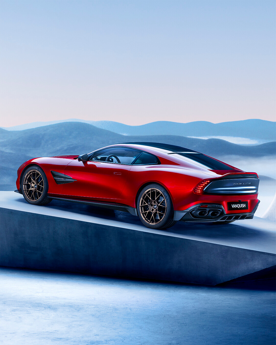 Rear-quarter launch visual of the red Vanquish.