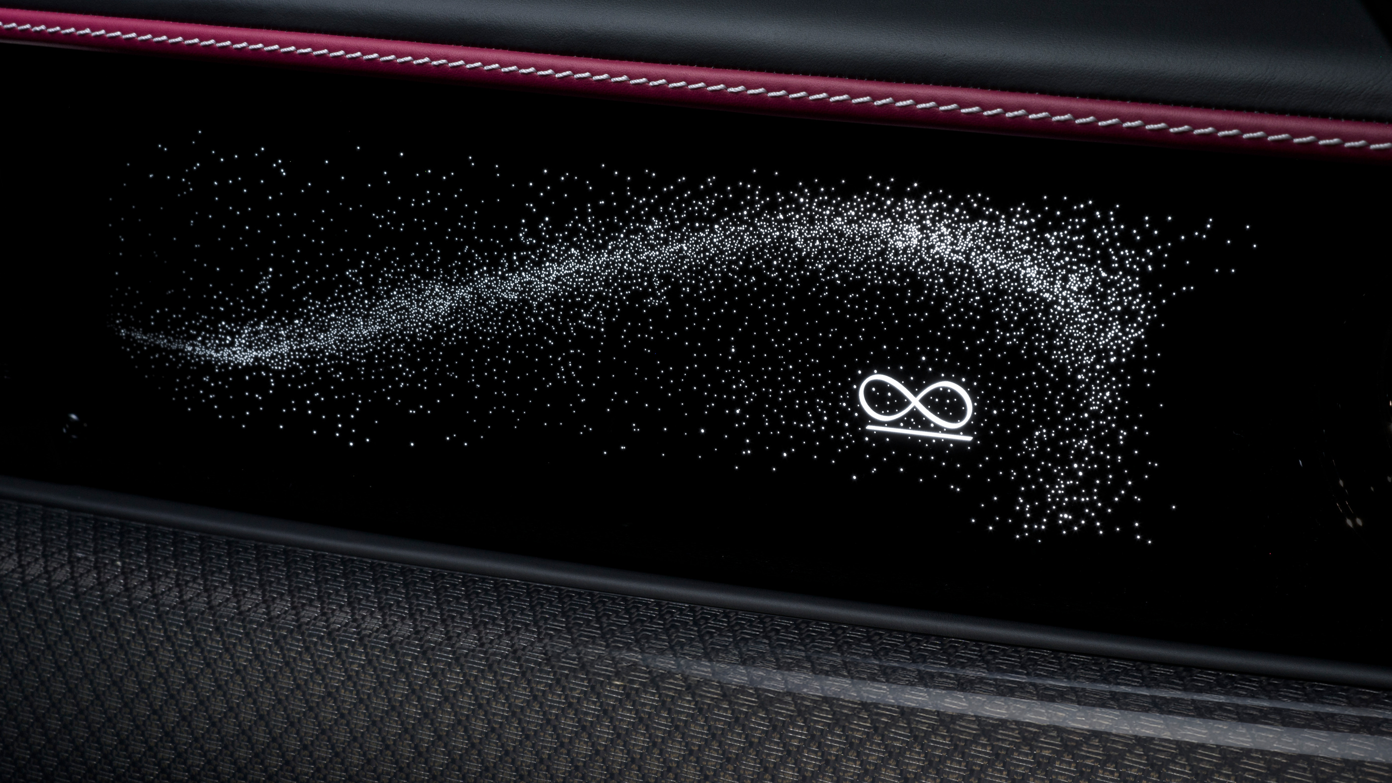 Illuminated fascia with the Black Badge infinity symbol.