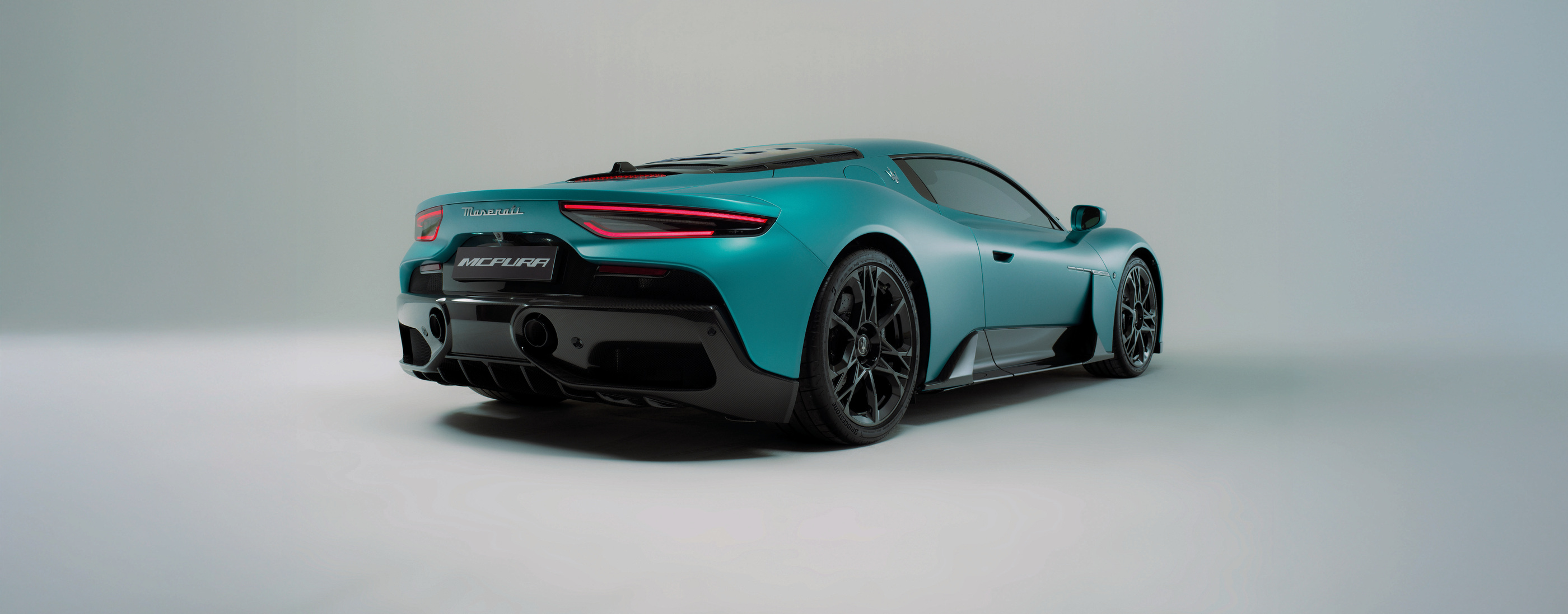 Official catalogue studio visual of the MCPURA coupé from the rear quarter.