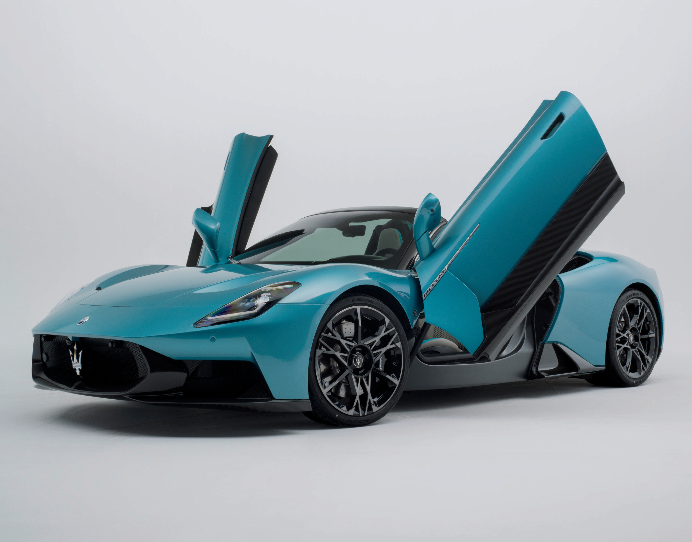 MCPURA with its butterfly doors raised in an official catalogue studio visual.