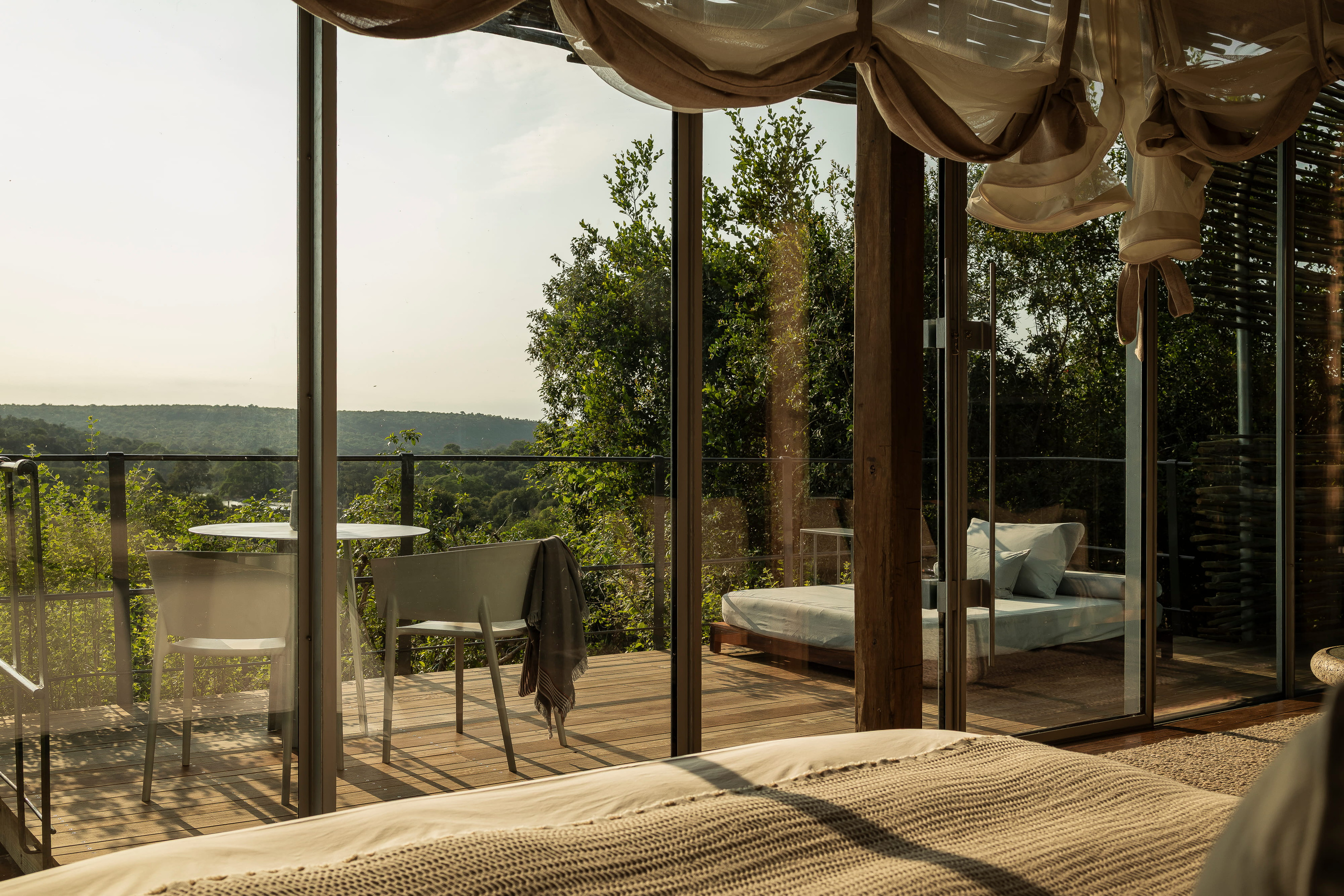 Lebombo interior opening towards its elevated outdoor deck in current official imagery.