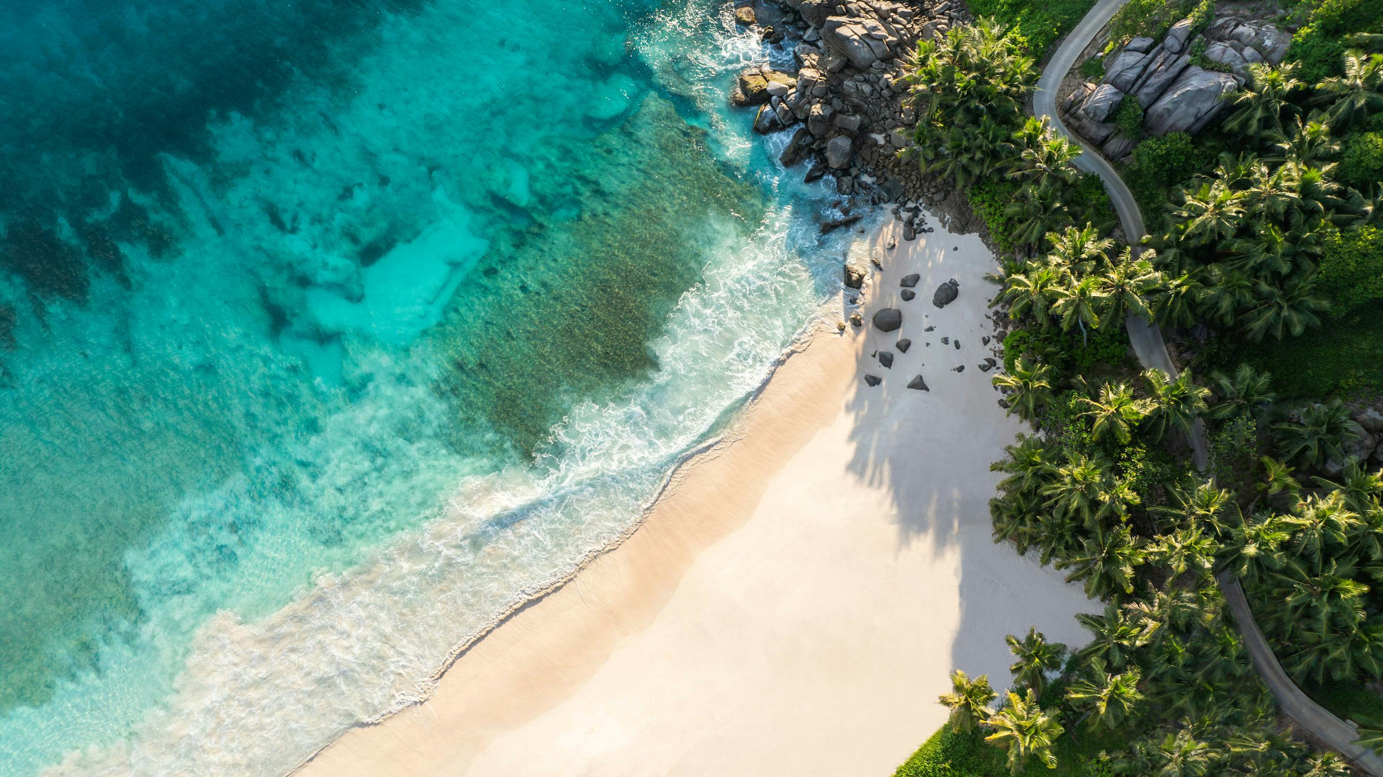 Anse Intendance and its granite edge in Cheval Blanc Seychelles’ official aerial imagery.