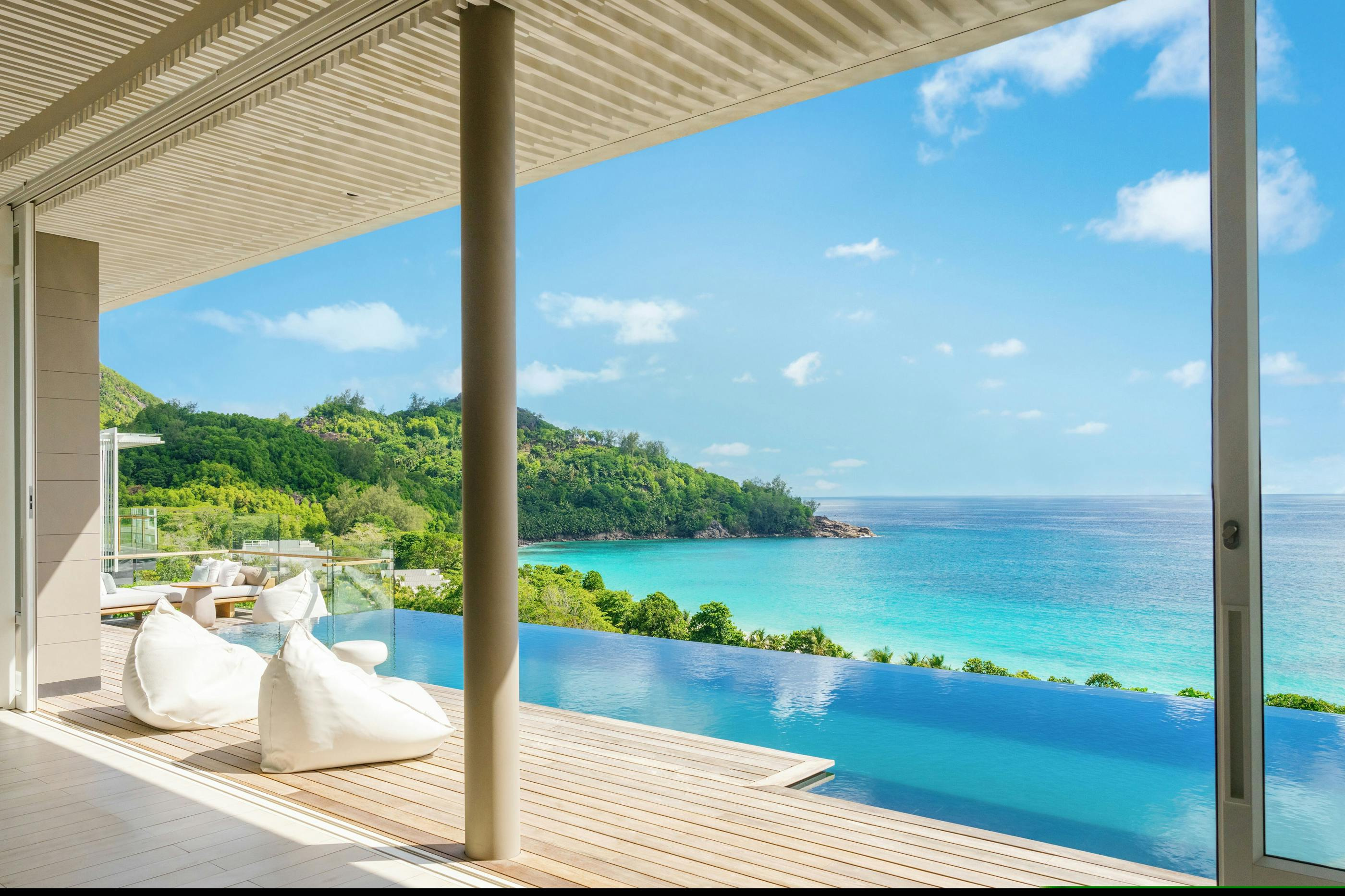 A villa terrace looking across the pool towards the beach.
