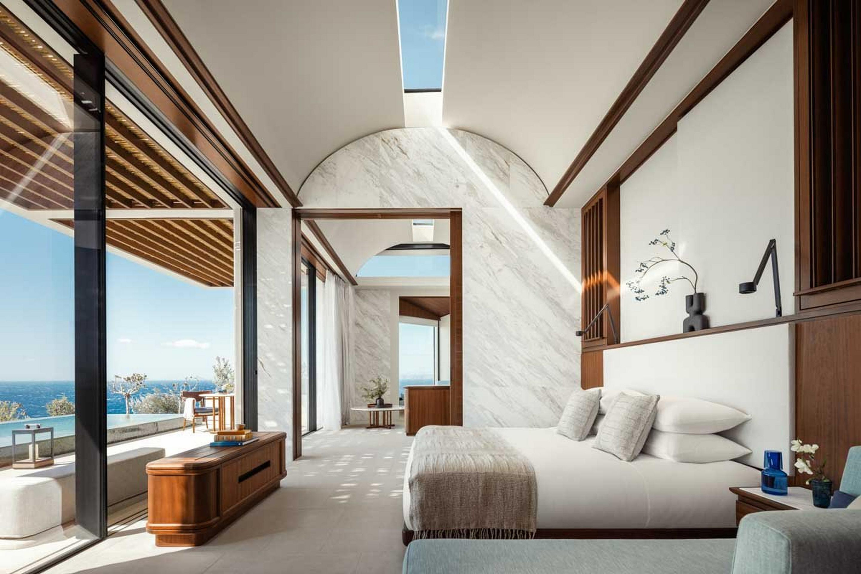 Cliffside bedroom with a broad opening towards its private outdoor setting.