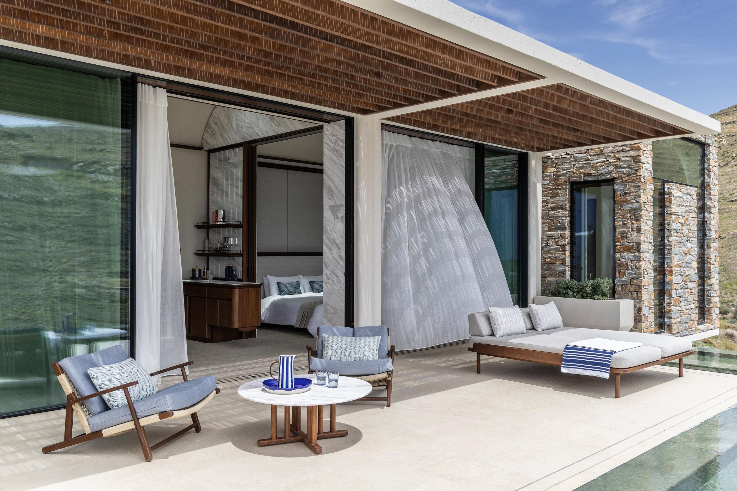 Outdoor shower and daybed in the resort’s official villa imagery.