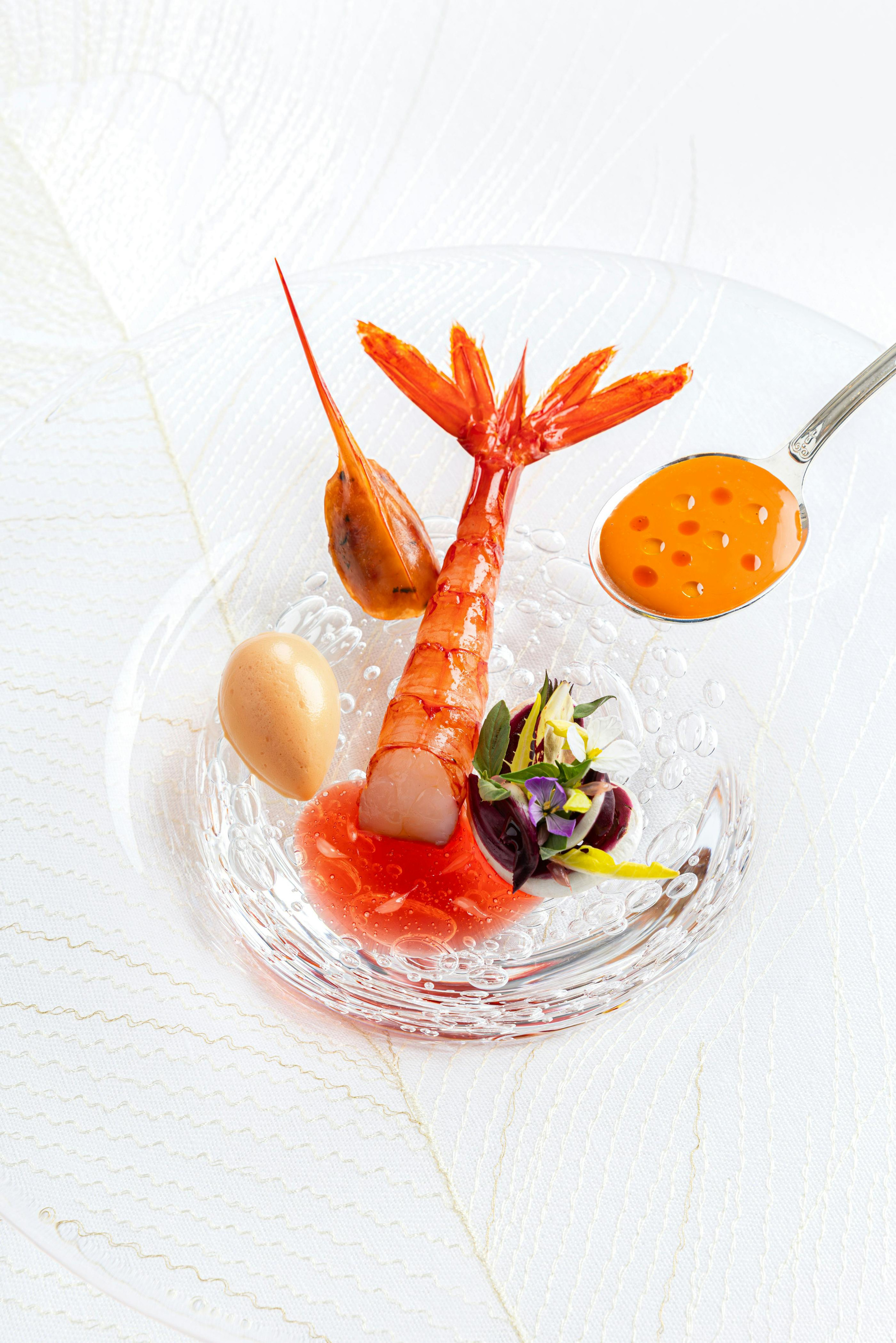 A plated composition with a separate sauce at Plénitude.