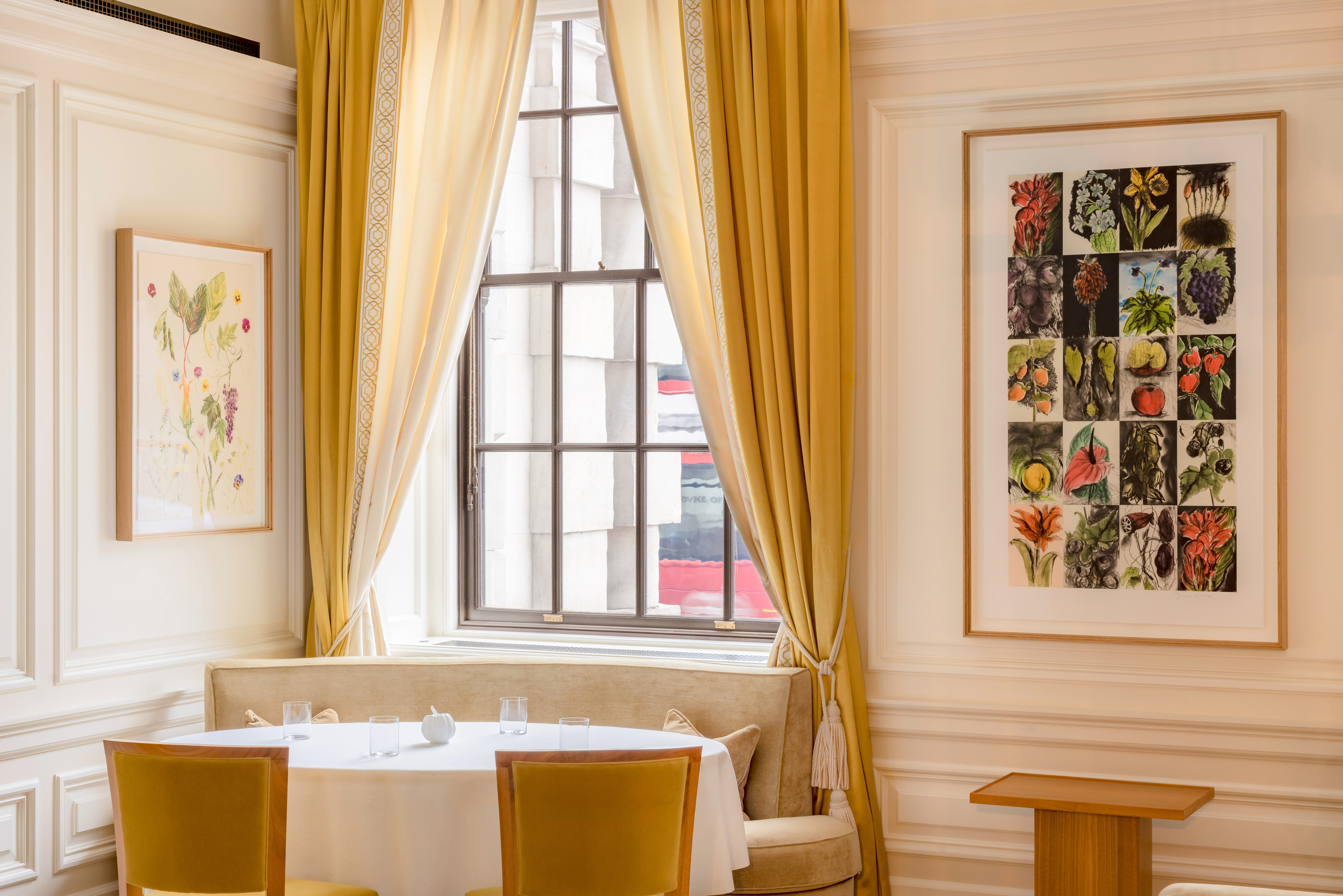 Table, windows and botanical artwork in the Whitehall dining room.