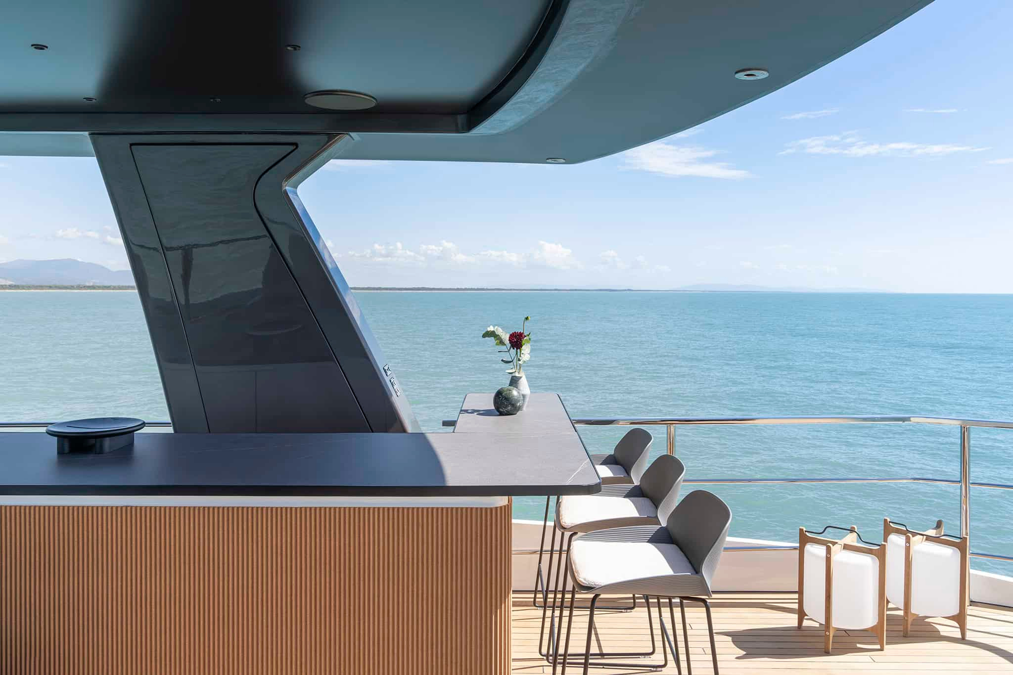 An outdoor bar and framed horizon aboard Grande 36M.