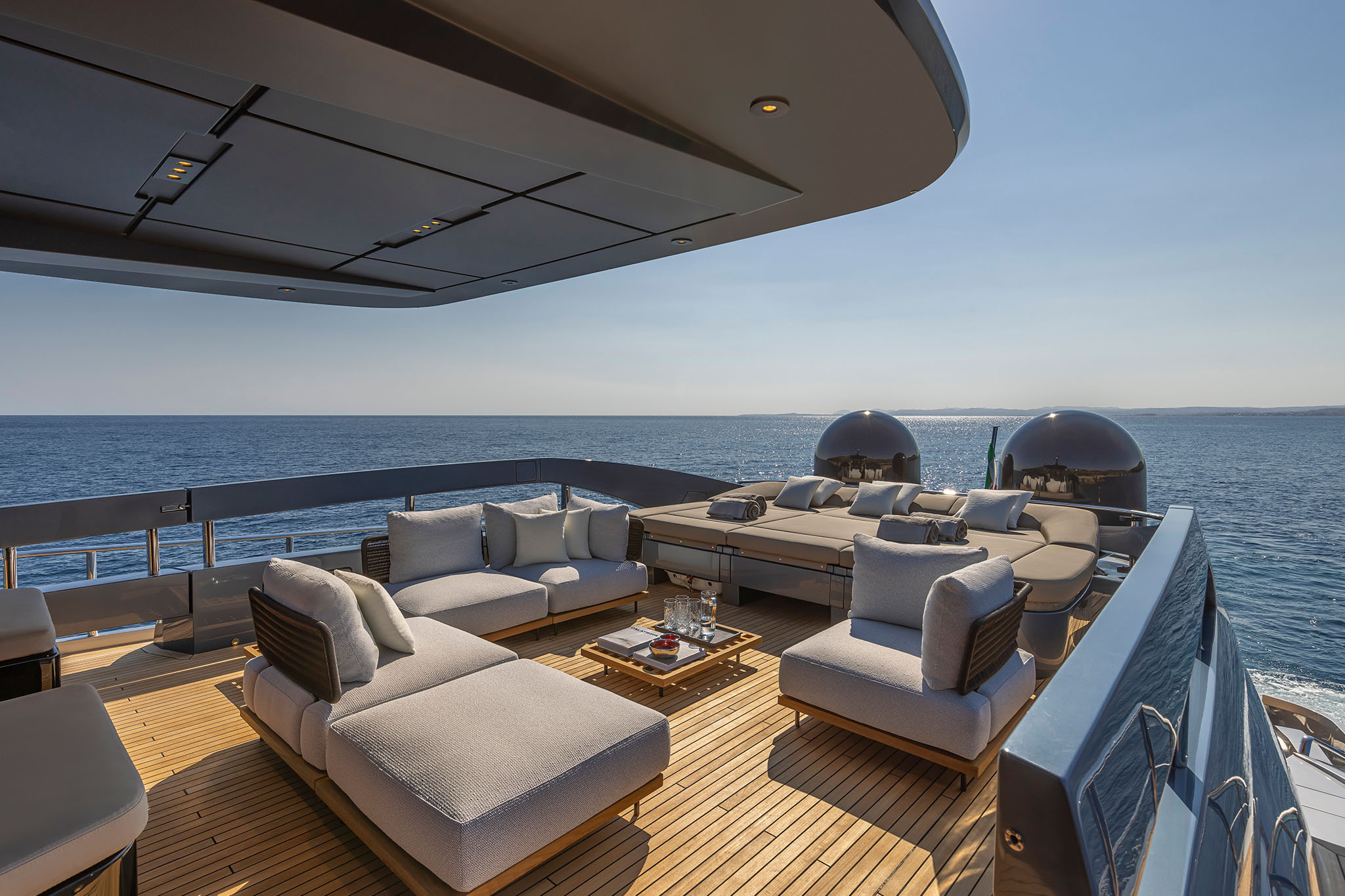 A sheltered GTX116 aft sitting area opening towards the water.