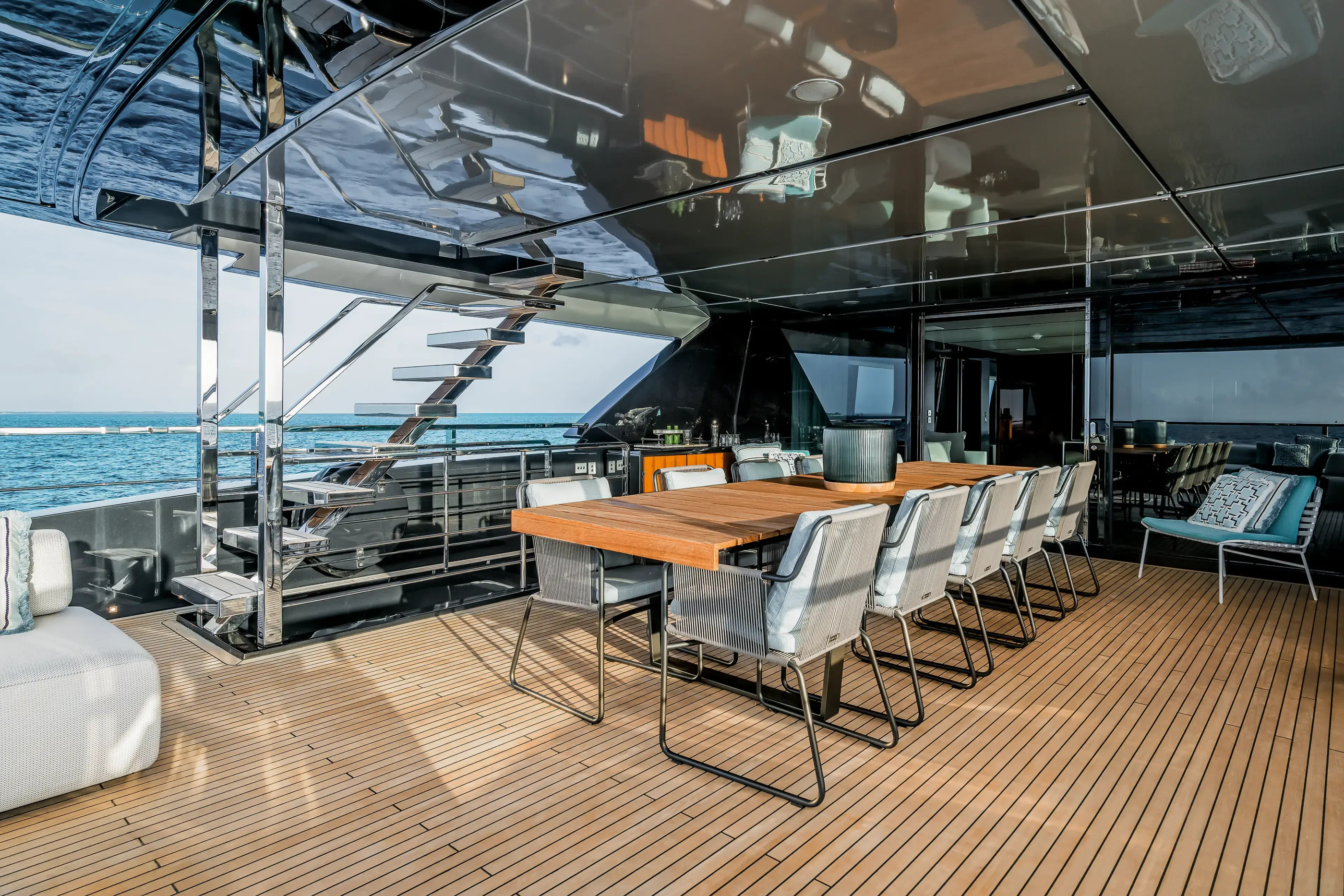 Covered outdoor dining setting on Riva 130 Bellissima.