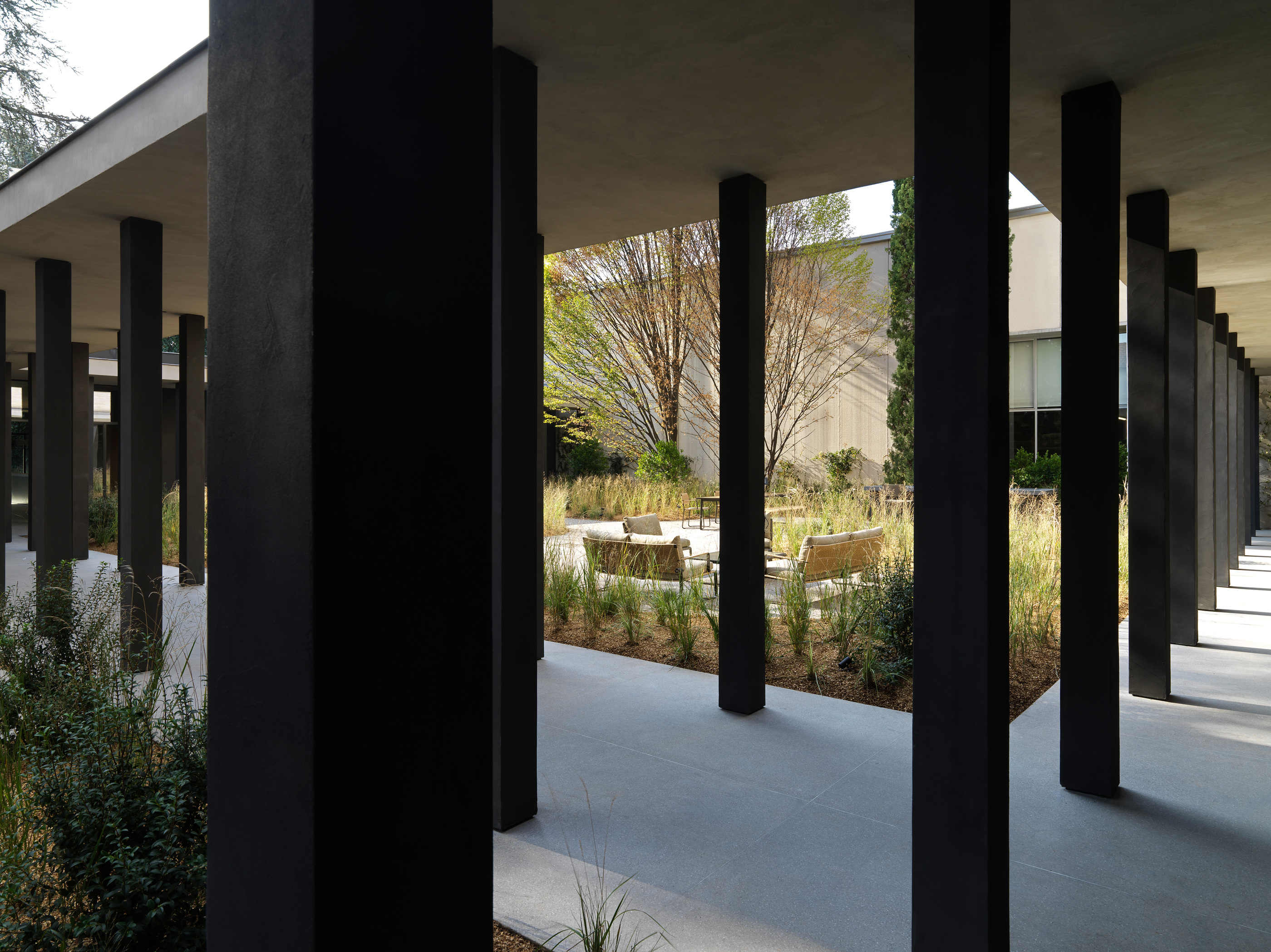 The Pavilion colonnade frames the route alongside the garden.