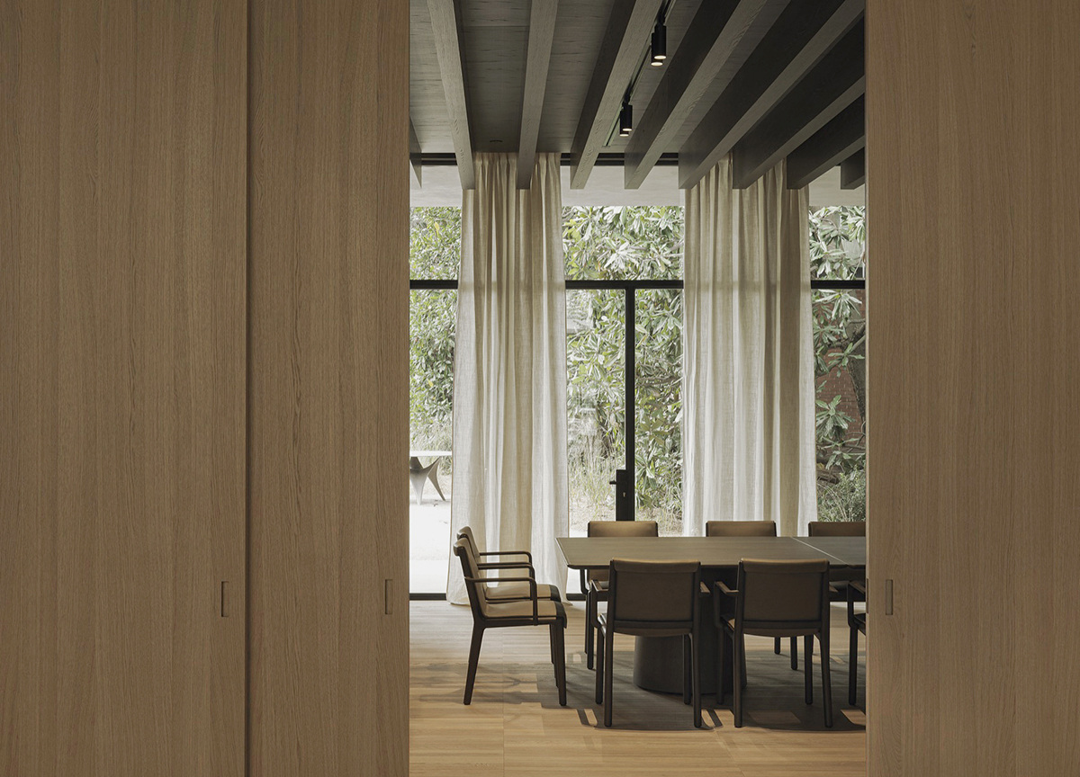 Dining furniture and timber-lined interior within the Pavilion. Photograph by Max Zambelli, courtesy Vincent Van Duysen.