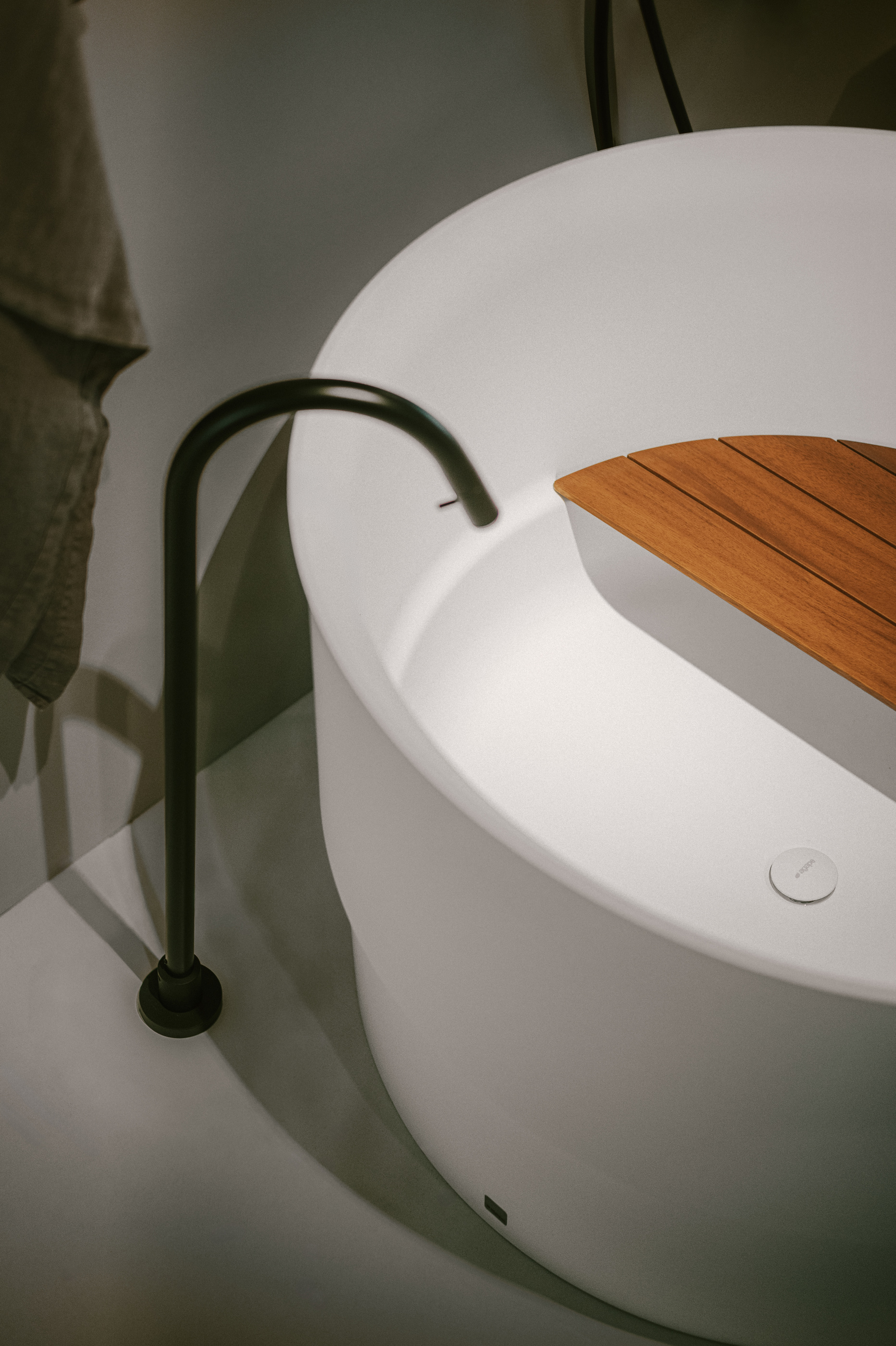 Round Agape Immersion with the integrated timber seat, in the official 2026 showroom photography.