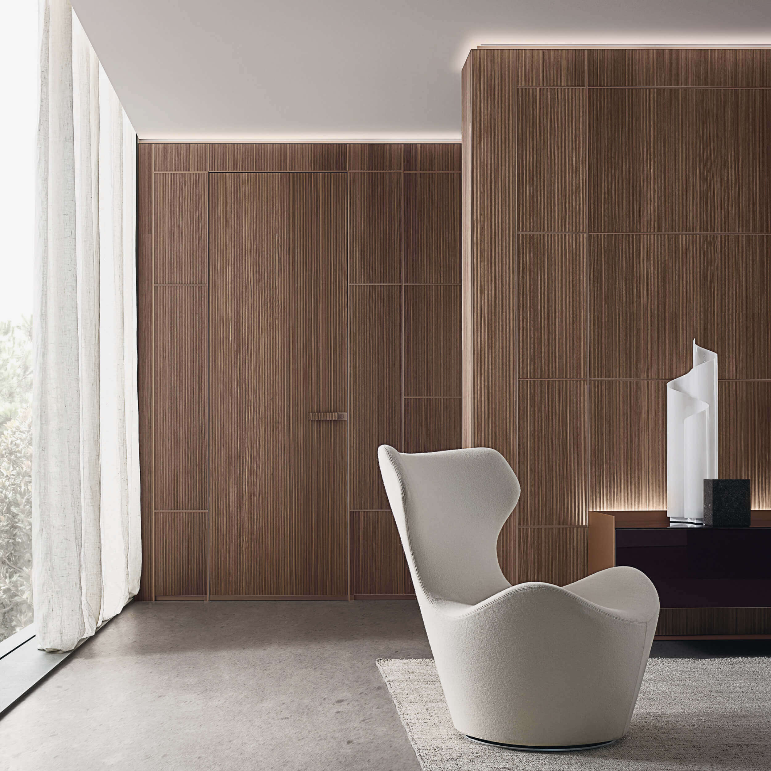 A seat and the panelled wall show the system at occupied room scale.