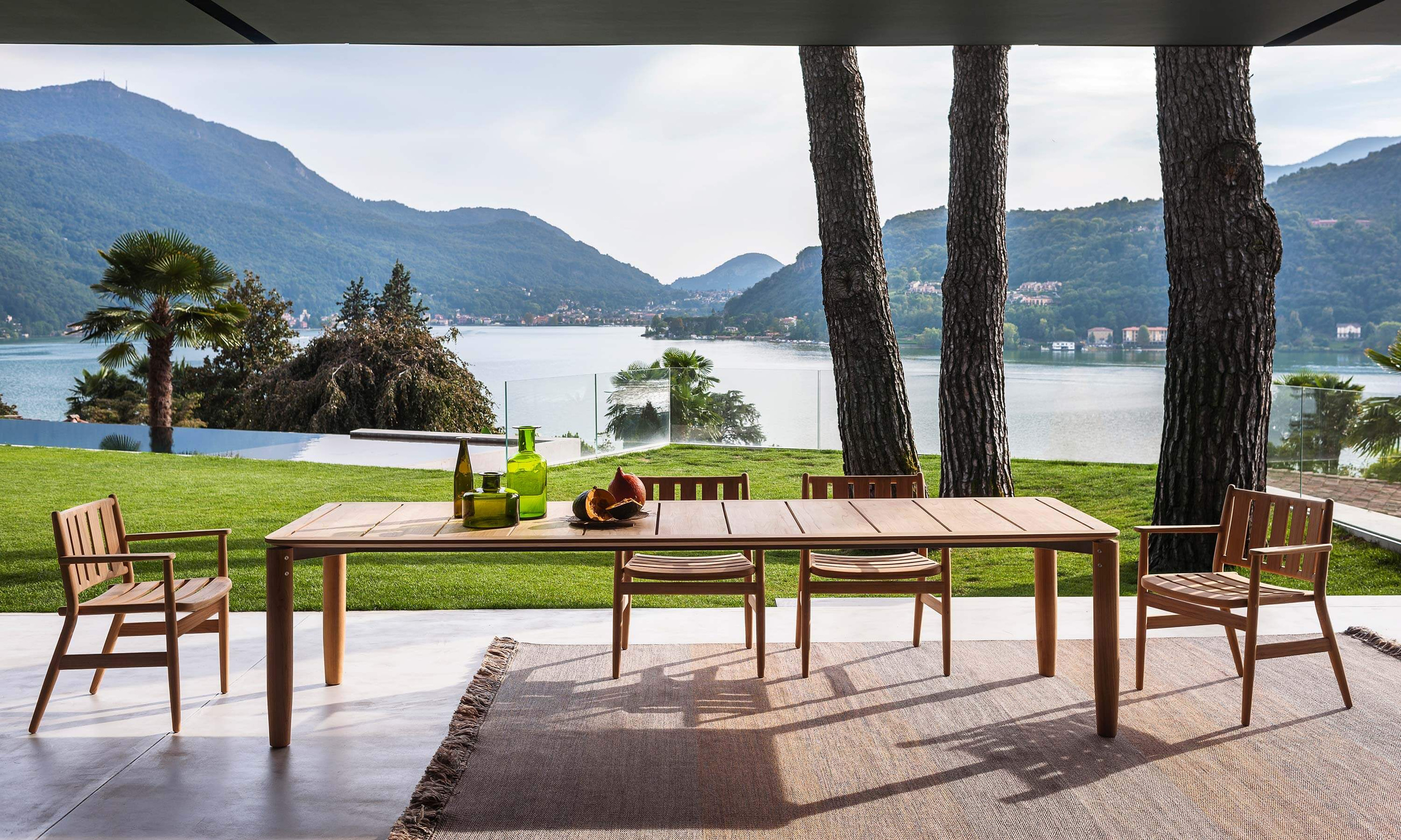 RODA Levante dining furniture on a terrace facing the lake.
