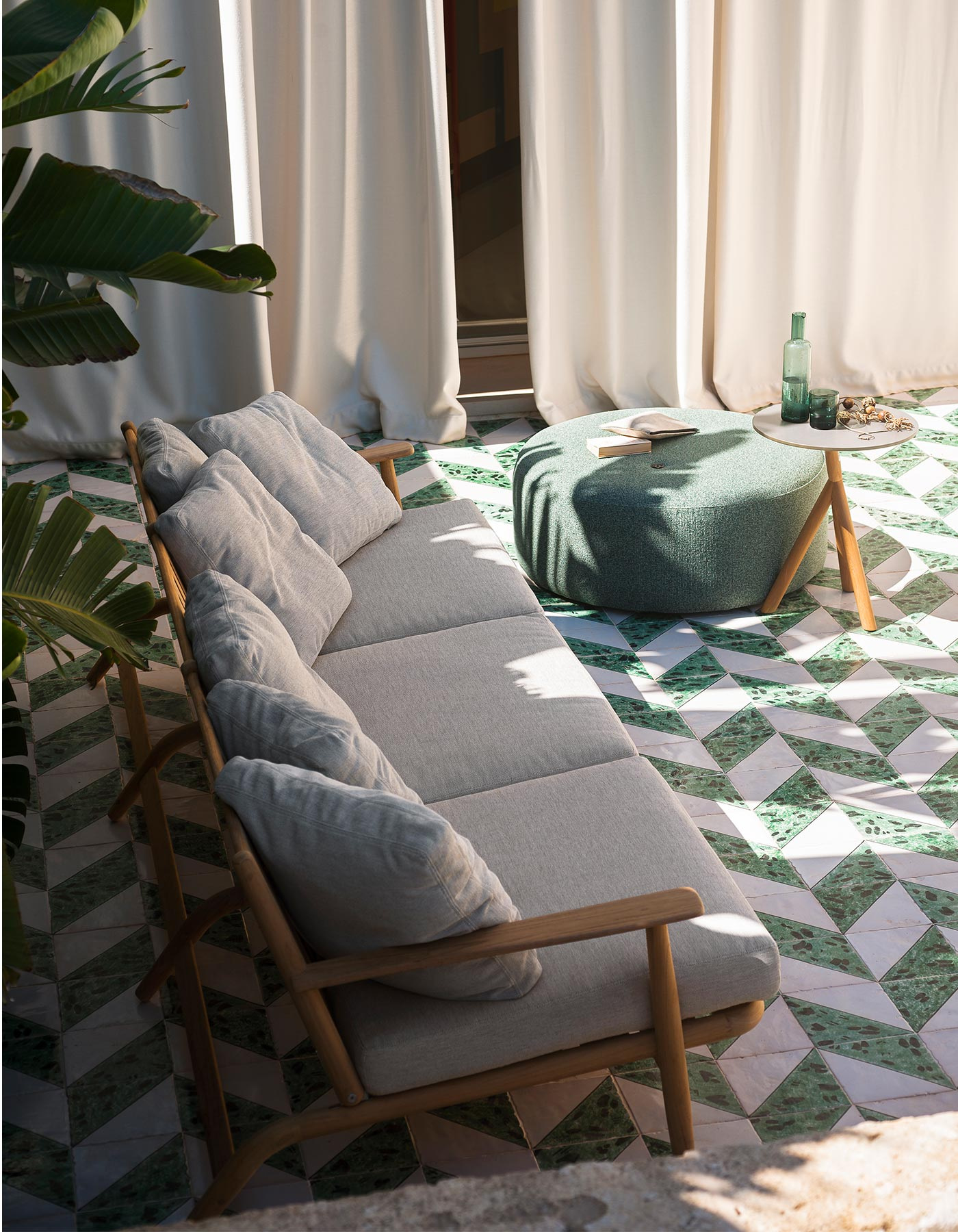 The cushioned Levante sofa within a sheltered terrace setting.