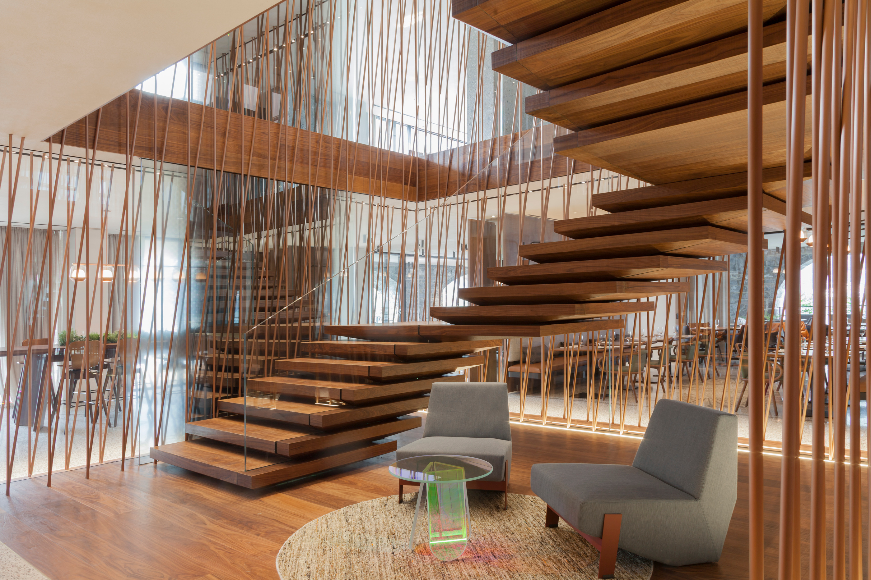 Timber treads and slender vertical elements define the hotel stair.