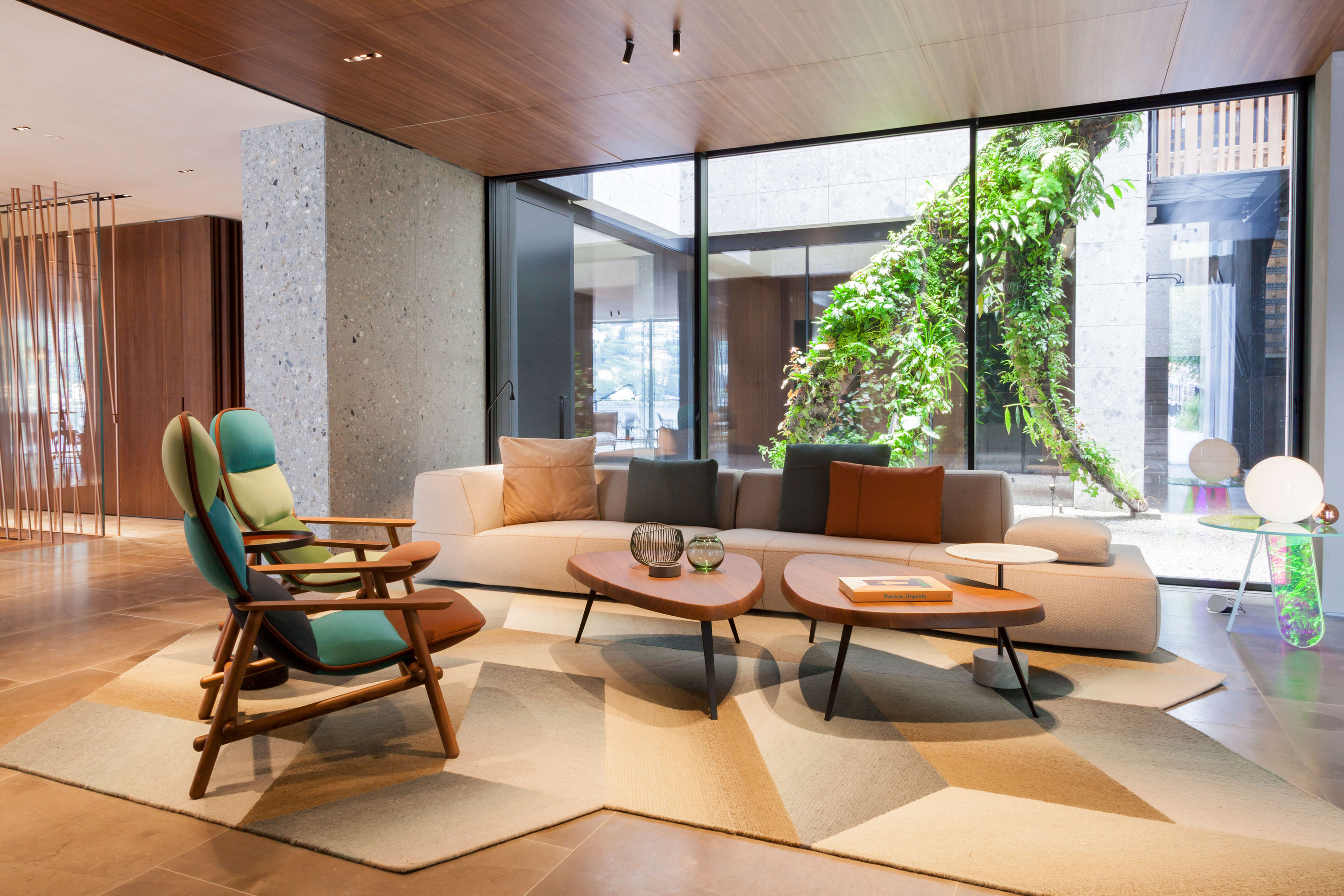 The lounge at Il Sereno, with upholstered furniture inside a strong architectural frame.