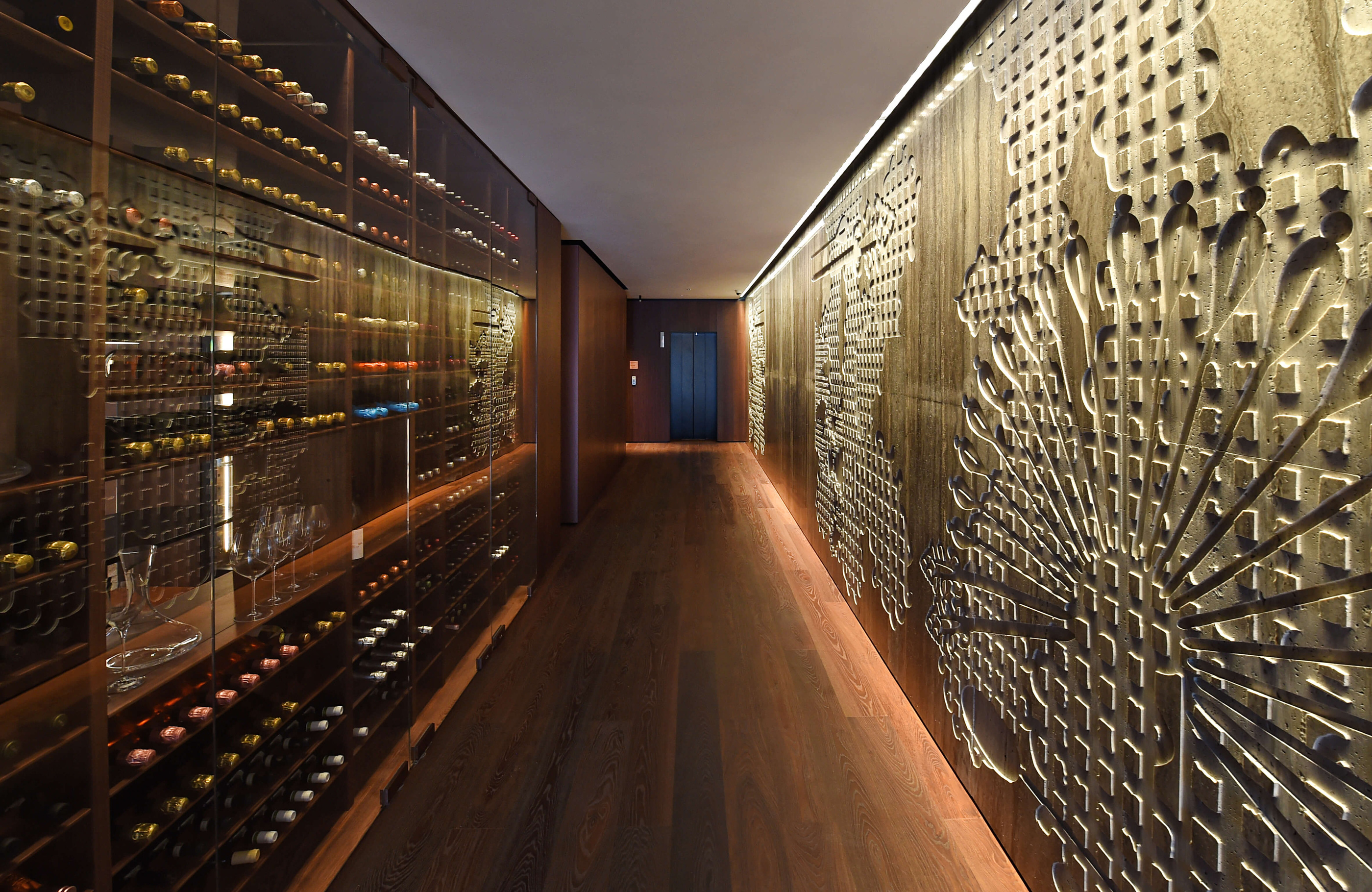The corridor and its textured wall within the hotel’s material sequence.