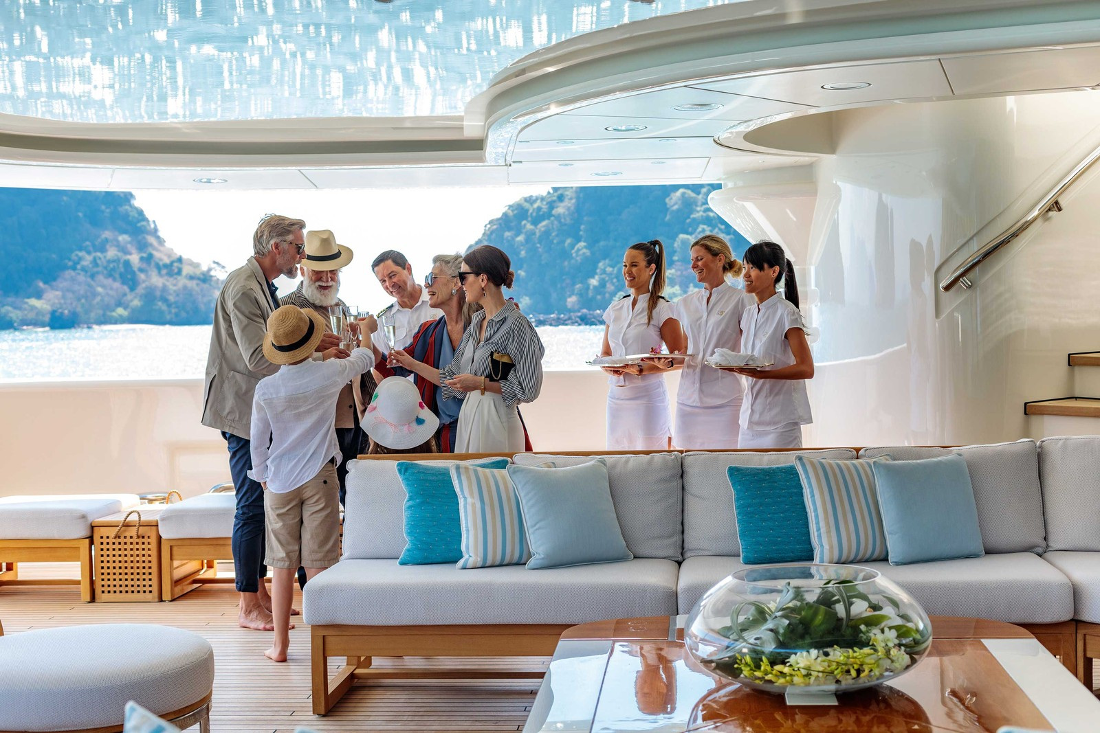 Hospitality aboard a yacht in Burgess’s official charter-management imagery.