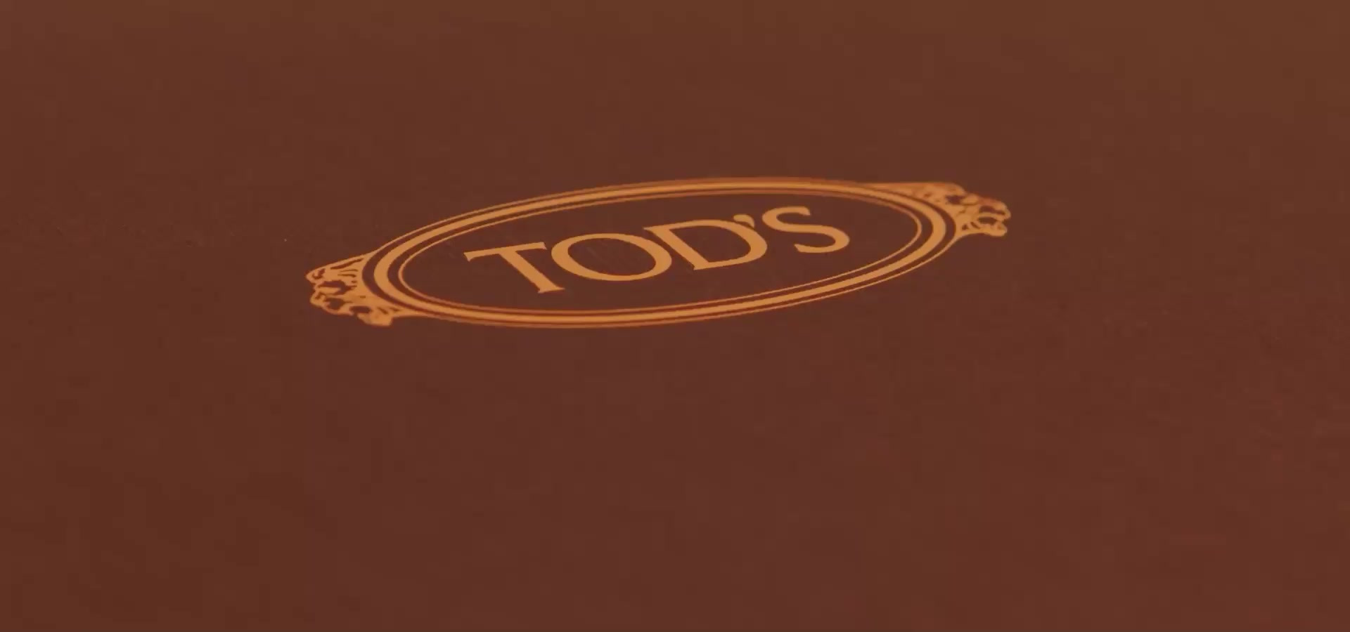 Tod’s maker mark on leather in the official Aura case-study visual.